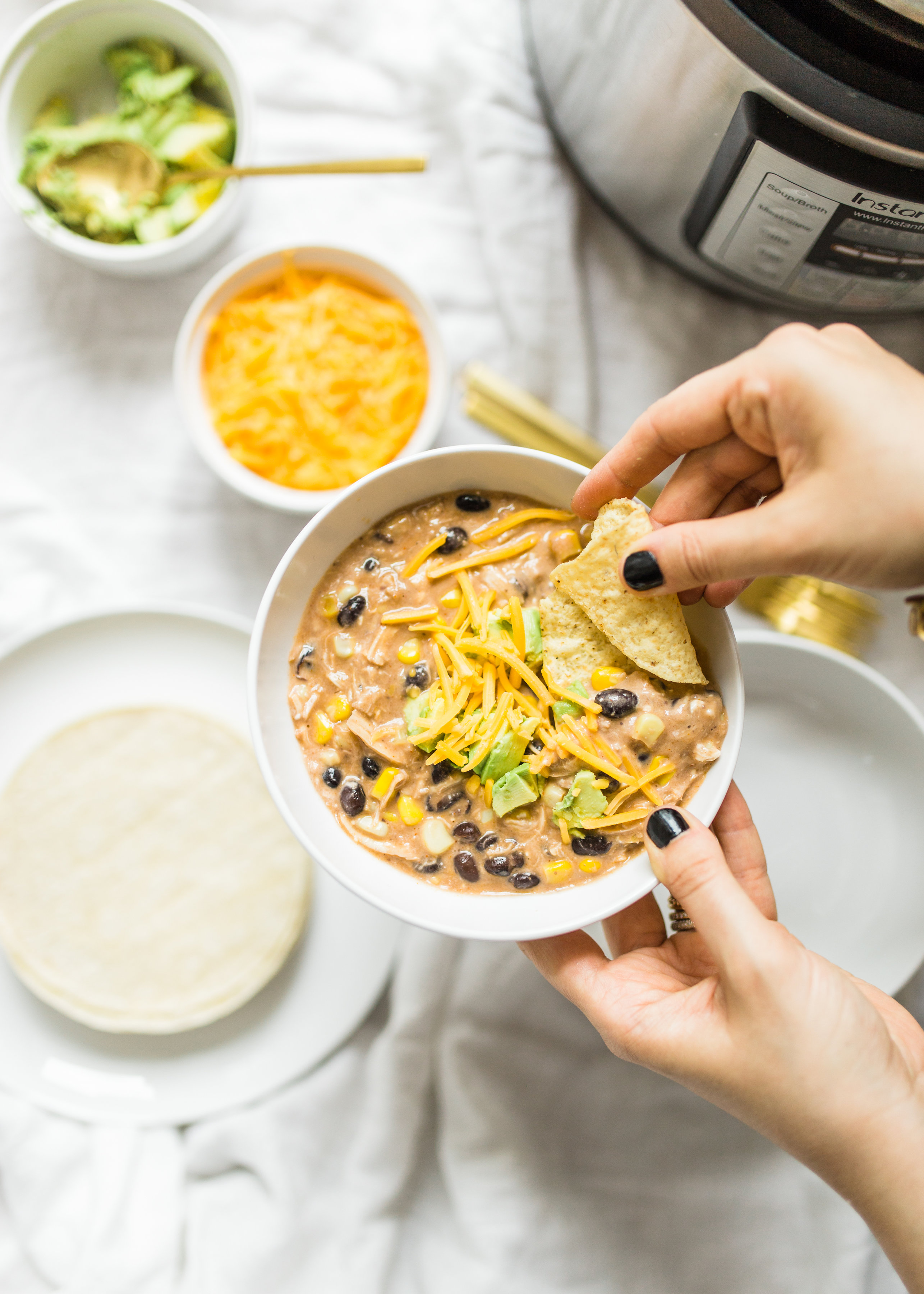 This easy and delicious creamy chicken enchilada soup is made in a crockpot or Instant Pot - a.k.a., dump it and forget it. Our whole family loves it. #crockpot #crockpotmeals #crockpotdinner #instantpot #instantpotdinner #instantpotchicken #crockpotchicken #chickenenchiladas #crockpotenchiladas #instantpotenchiladas #slowcooker #slowcookersoup #slowcookerenchiladas #slowcookermeals Click through for the recipe. | glitterinc.com | @glitterinc