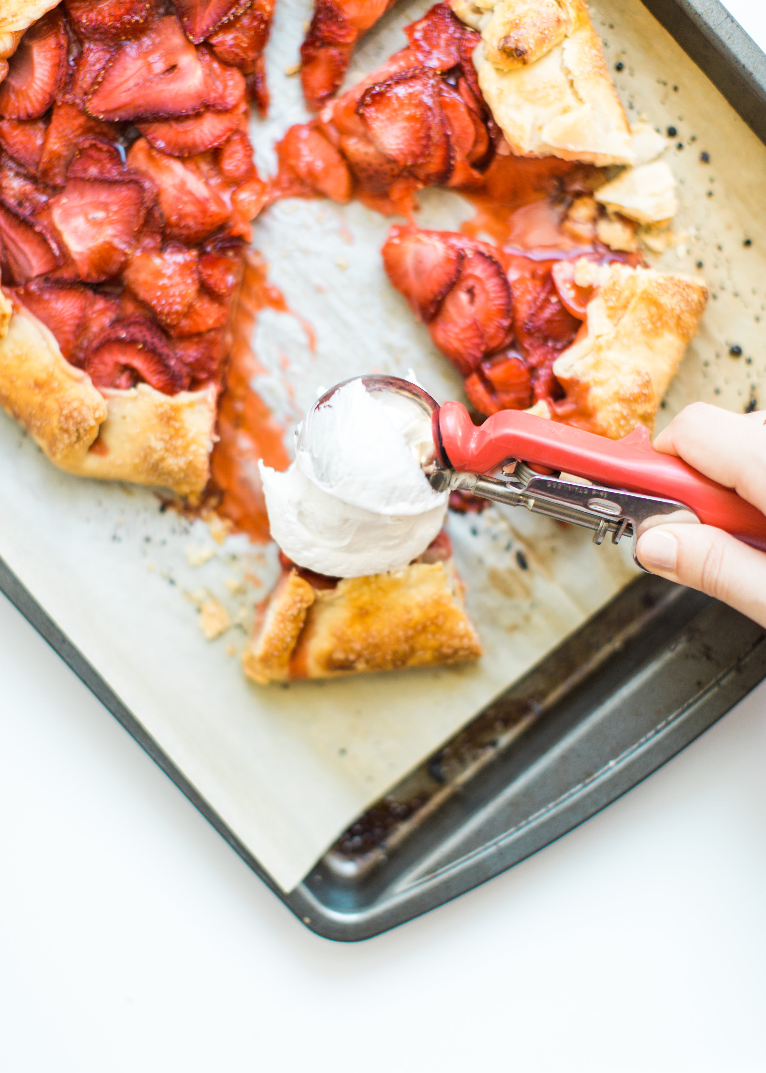 Flaky pie dough, a sweet jam and fresh strawberry filling, and a sprinkling of turbinado sugar on the crust, makes this simple strawberry galette or crostata, a.k.a., pie made easy using store-bought crust, the stuff of dreams. Click through for the recipe. #pie #strawberrypie #strawberrygalette #strawberrycrostata #crostata #galette #simplesummerdessert #summerdessert #springdessert #simpledessert #easydessert #easypie #simplepie | glitterinc.com | @glitterinc