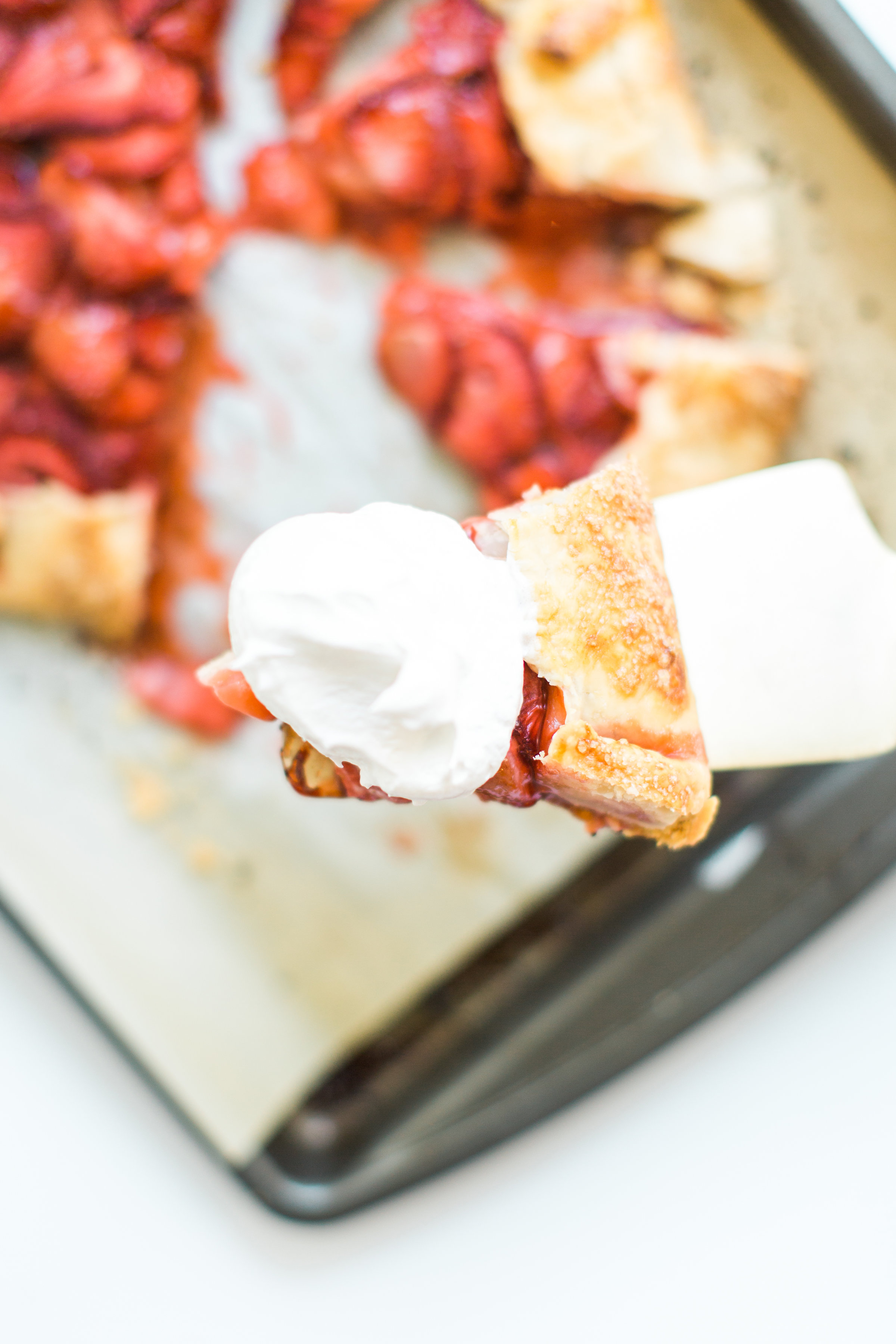 Flaky pie dough, a sweet jam and fresh strawberry filling, and a sprinkling of turbinado sugar on the crust, makes this simple strawberry galette or crostata, a.k.a., pie made easy using store-bought crust, the stuff of dreams. Click through for the recipe. #pie #strawberrypie #strawberrygalette #strawberrycrostata #crostata #galette #simplesummerdessert #summerdessert #springdessert #simpledessert #easydessert #easypie #simplepie | glitterinc.com | @glitterinc