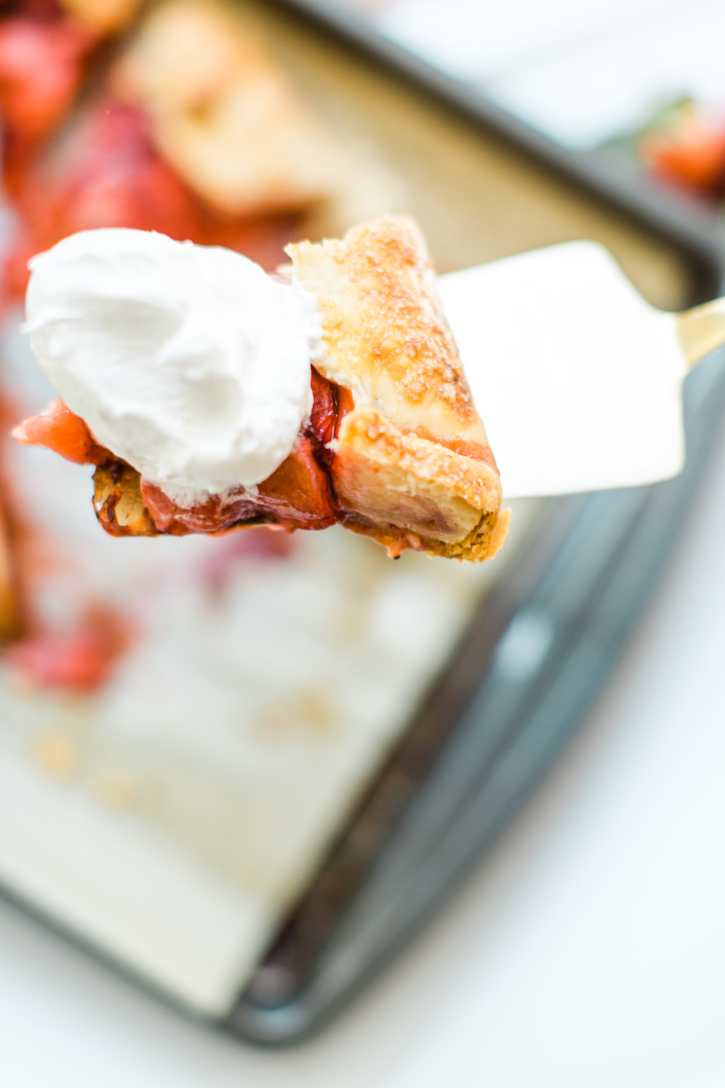 Flaky pie dough, a sweet jam and fresh strawberry filling, and a sprinkling of turbinado sugar on the crust, makes this simple strawberry galette or crostata, a.k.a., pie made easy using store-bought crust, the stuff of dreams. Click through for the recipe. #pie #strawberrypie #strawberrygalette #strawberrycrostata #crostata #galette #simplesummerdessert #summerdessert #springdessert #simpledessert #easydessert #easypie #simplepie | glitterinc.com | @glitterinc