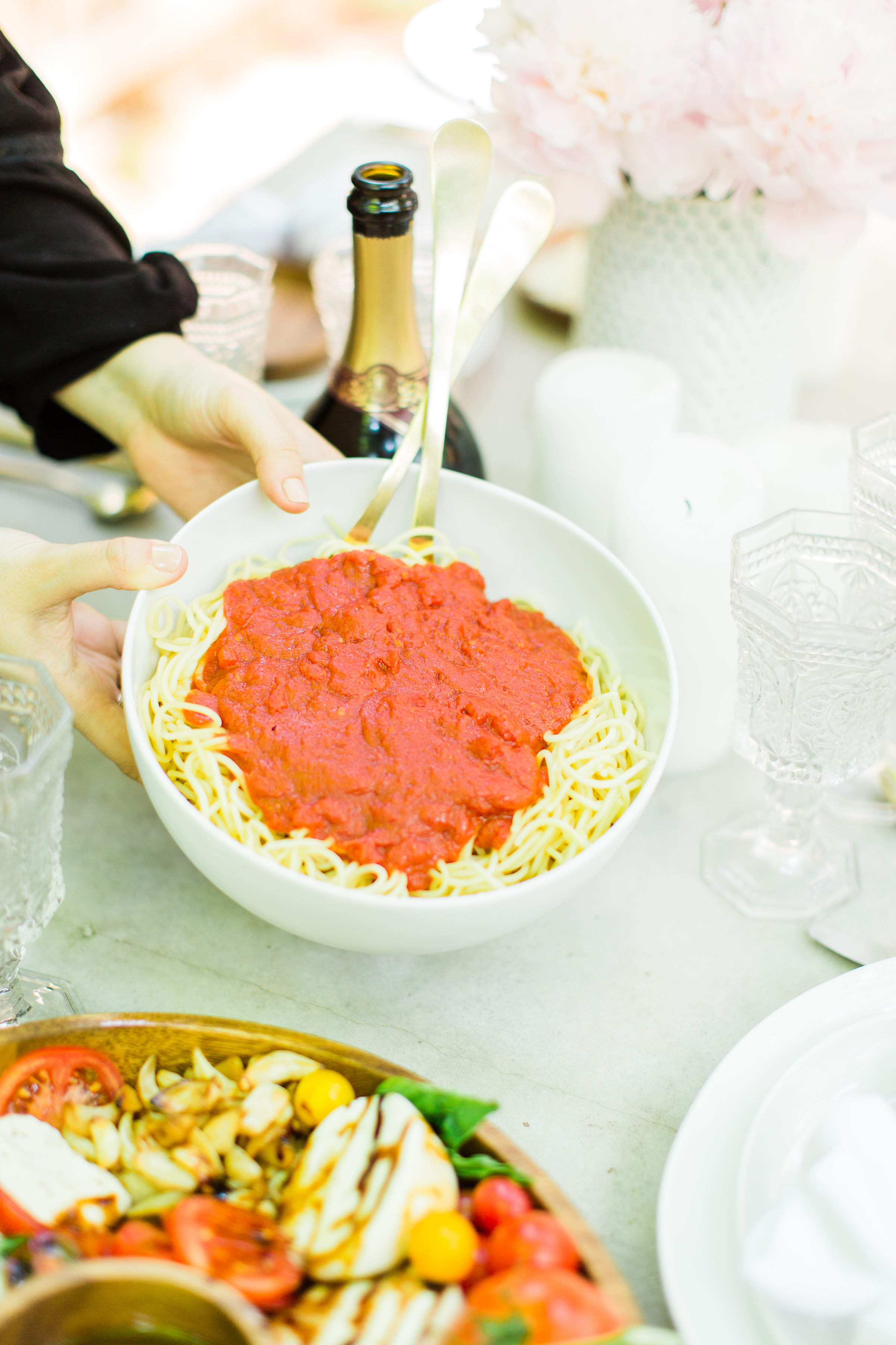 Throw an easy, light-hearted, and fun get-together for friends and family with one of our favorites - the spaghetti dinner party. Sharing how we throw a memorable spaghetti dinner - that everyone will love - in just a few simple steps! #dinnerparty #spaghettidinner #pastadinner #italiandinnerparty Click through for the details. | glitterinc.com | @glitterinc