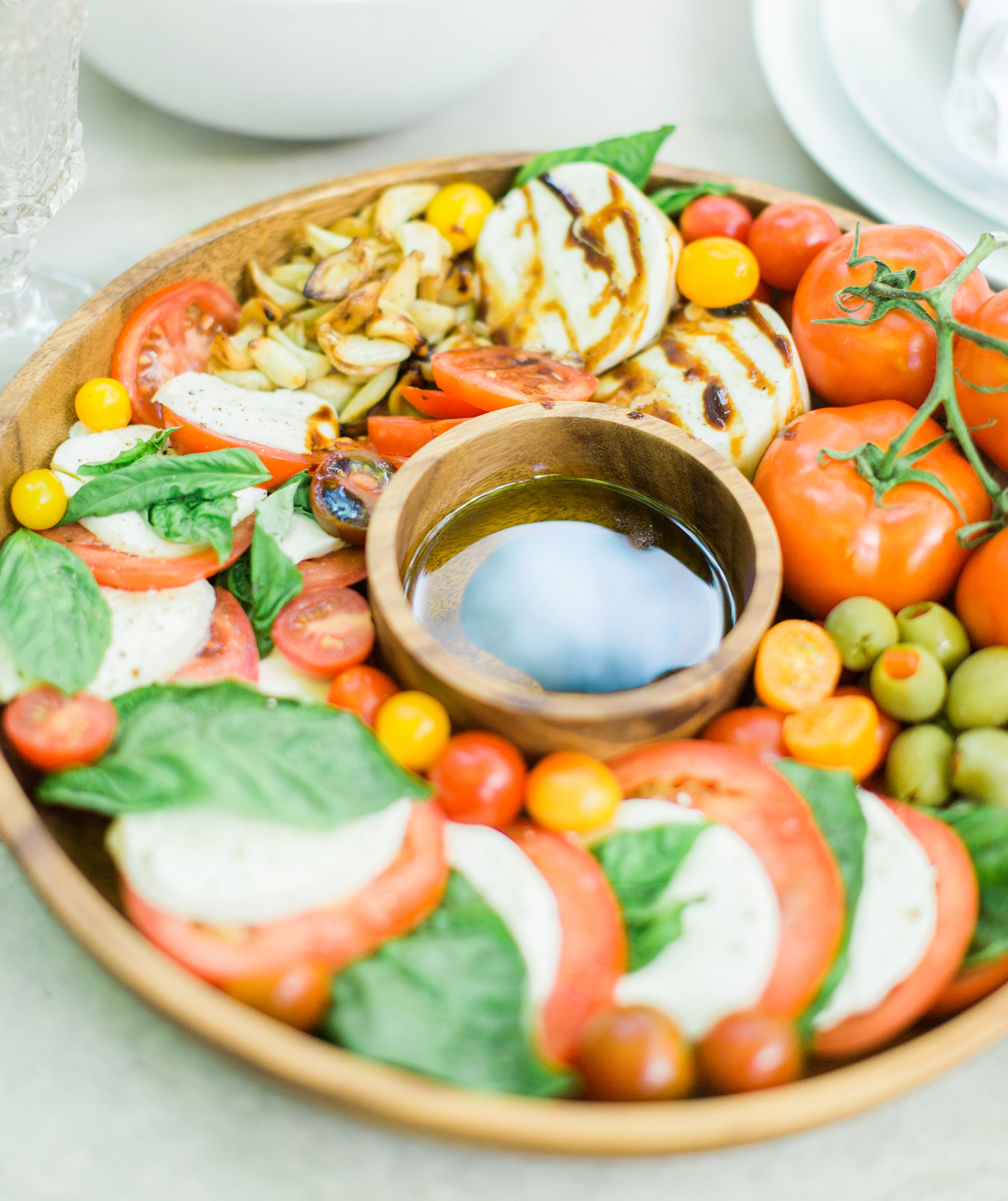 Tomatoes, fresh mozzarella, and basil drizzled with balsamic vinegar, or a sweet balsamic reduction, and olive oil; a caprese salad platter is so easy to make, looks beautiful and impressive (hello, wow factor!), and the magical combination of flavors is totally delicious. Click through for the recipe. #caprese #capresesalad #capresesaladplatter #appetizer #salad #partyfood #recipe #capreserecipe | glitterinc.com | @glitterinc