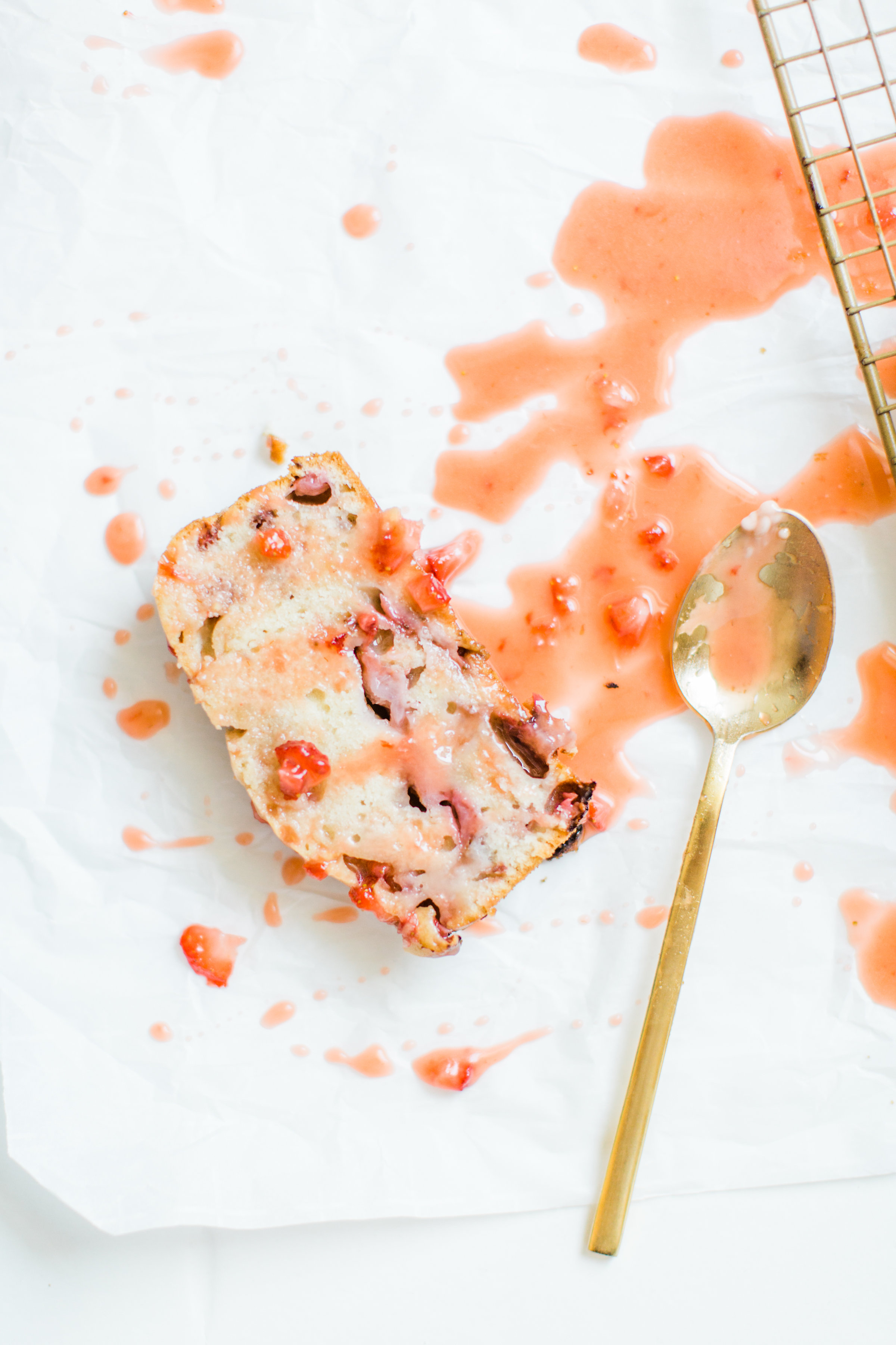 If you love strawberries, you are going to go crazy for this knock-your-socks-off easy and delicious strawberry bread with a decadent strawberry glaze. This quick bread recipe comes together in just 10 minutes, and will impress EVERYONE. #strawberrybread #quickbread #dessert #strawberrycake Click through for the recipe. | glitterinc.com | @glitterinc