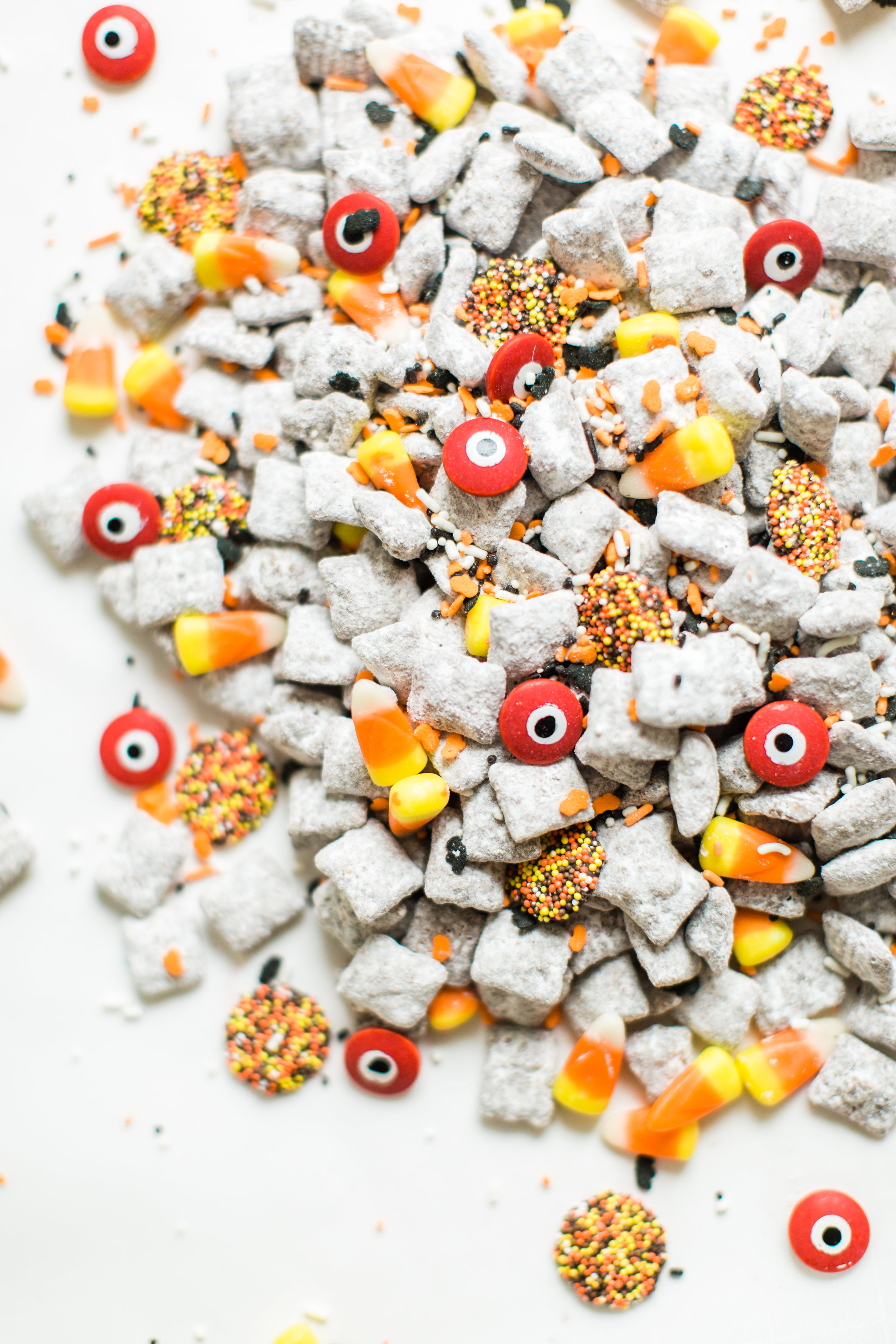 We turned classic - and delicious - Muddy Buddies; a.k.a., Puppy Chow, into a spooky treat; the perfect dessert for your next haunted Halloween party! Click through for the recipe. #halloween #halloweendessert #halloweencandy #halloweentreat #puppychow #halloweenpuppychow  #halloweenmuddybuddies | glitterinc.com | @glitterinc