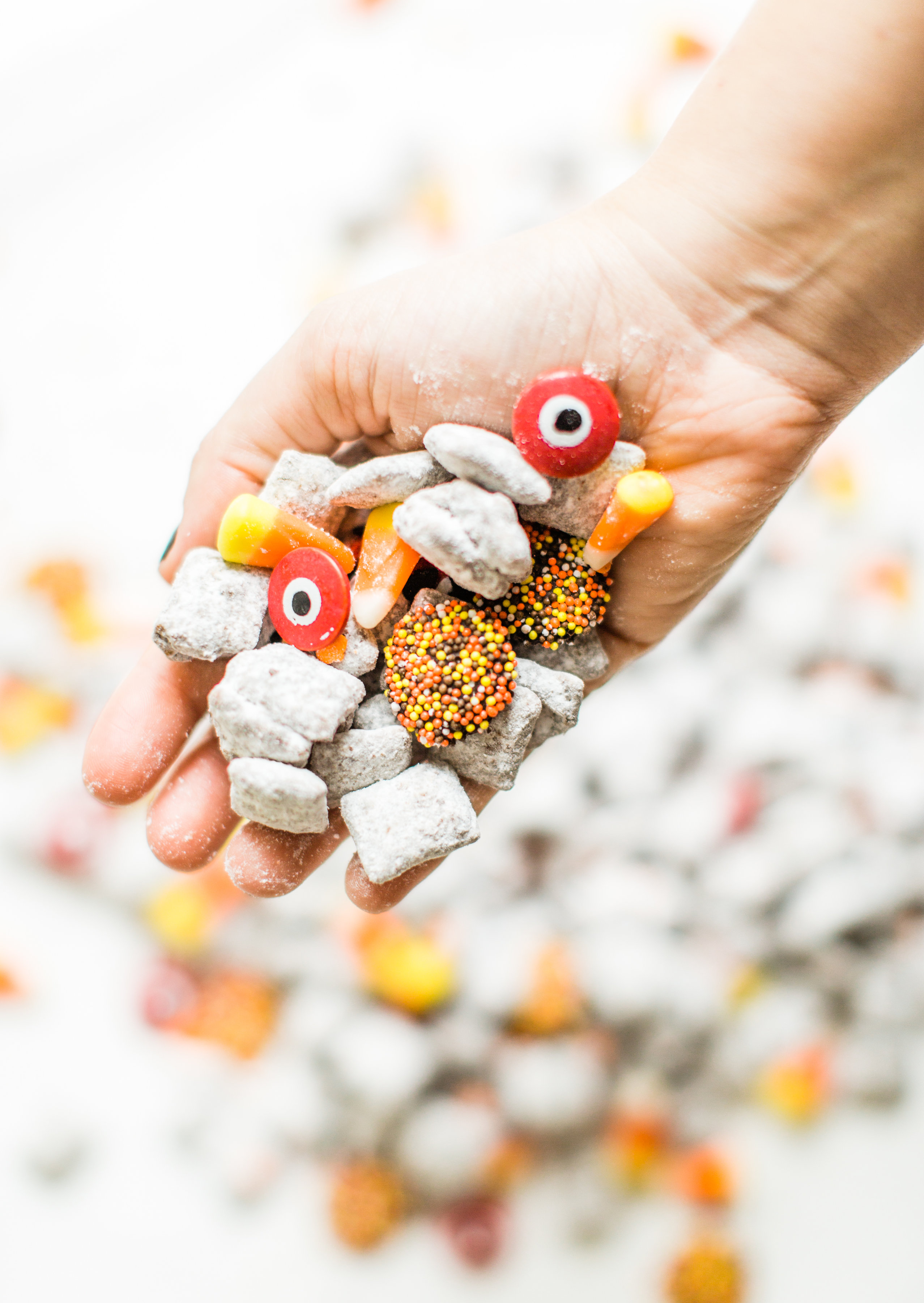 We turned classic - and delicious - Muddy Buddies; a.k.a., Puppy Chow, into a spooky treat; the perfect dessert for your next haunted Halloween party! Click through for the recipe. #halloween #halloweendessert #halloweencandy #halloweentreat #puppychow #halloweenpuppychow #muddybuddies #halloweenmuddybuddies | glitterinc.com | @glitterinc