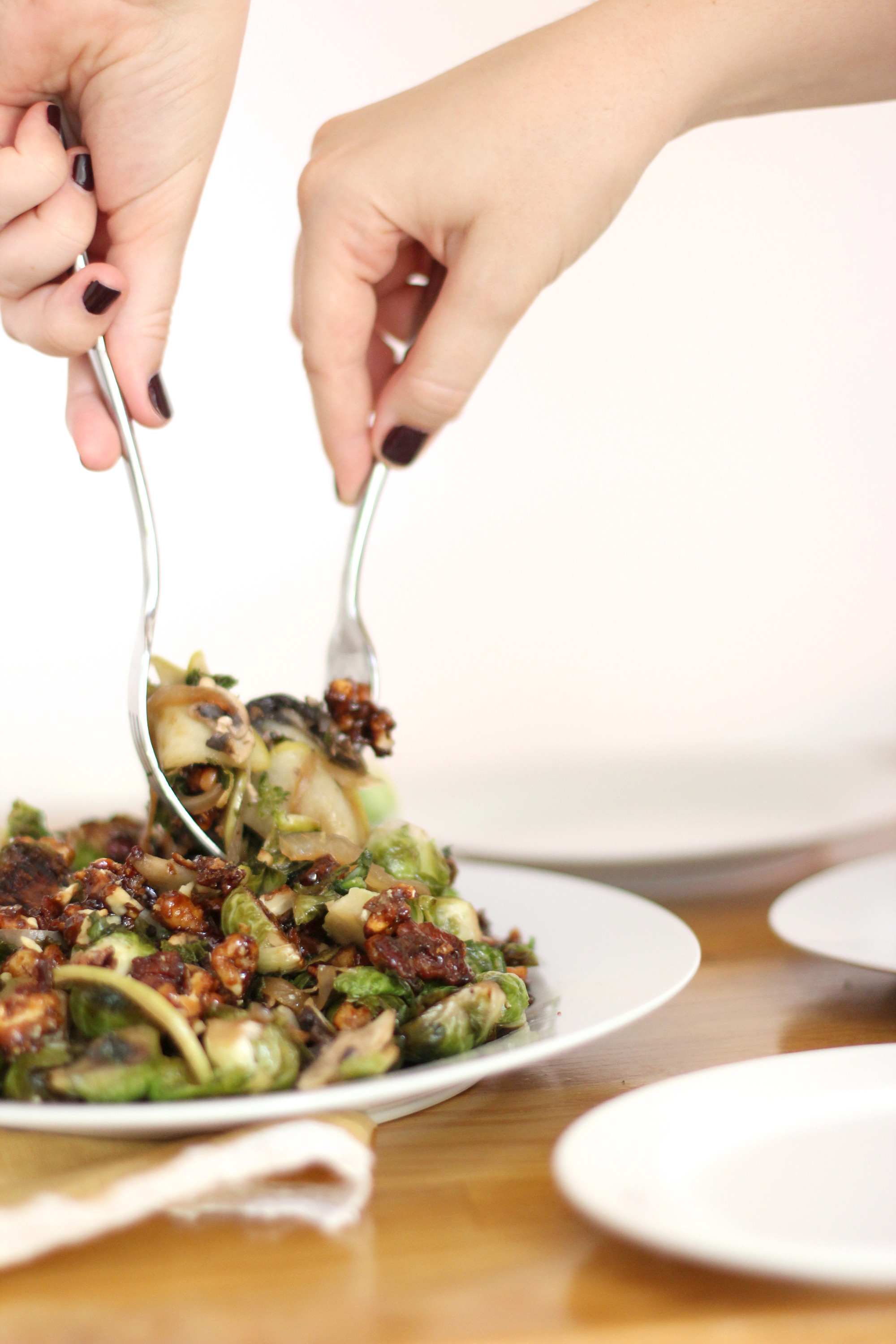 Brussels Sprouts with Candied Bacon and Walnuts - This one is a total crowd-pleaser; plus more than 125+ incredible fall recipes that everyone should try. Click through for the recipes. #fallrecipe #fallrecipes #thanksgiving #thanksgivingrecipe | glitterinc.com | @glitterinc