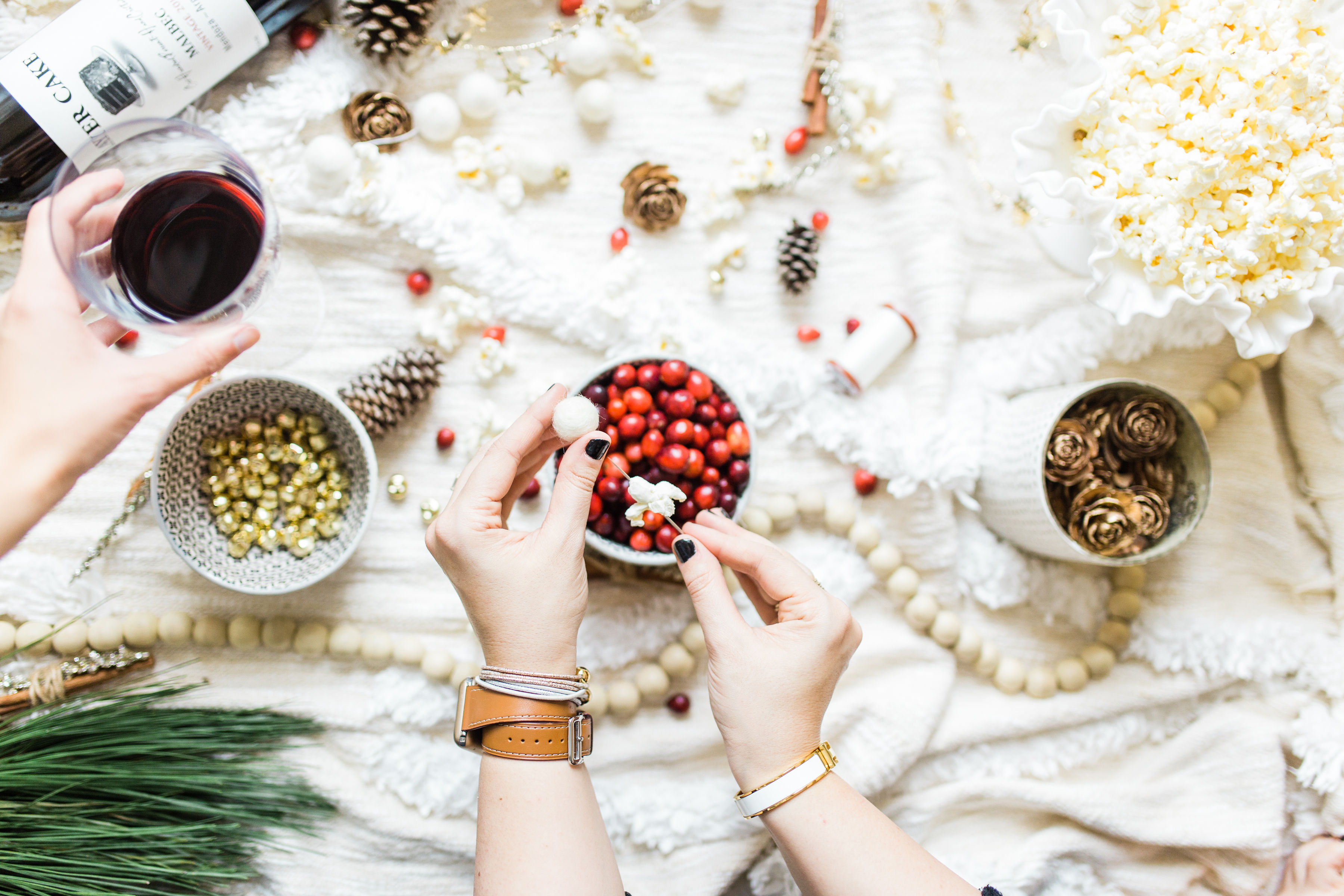 Looking for your next holiday party idea? Sip on wine and nibble on snacks while you make beautiful DIY holiday garlands with friends! (Bonus: The DIY holiday garland making party sets the stage for the perfect girls night in!) Click through for the details. #holidayparty #christmasparty #diychristmas #diyholidays #garland #holidaygarland #diyholidaygarland #diygarland #christmasgarland #holidaygirlsnight #christmasgirlsnight | glitterinc.com | @glitterinc