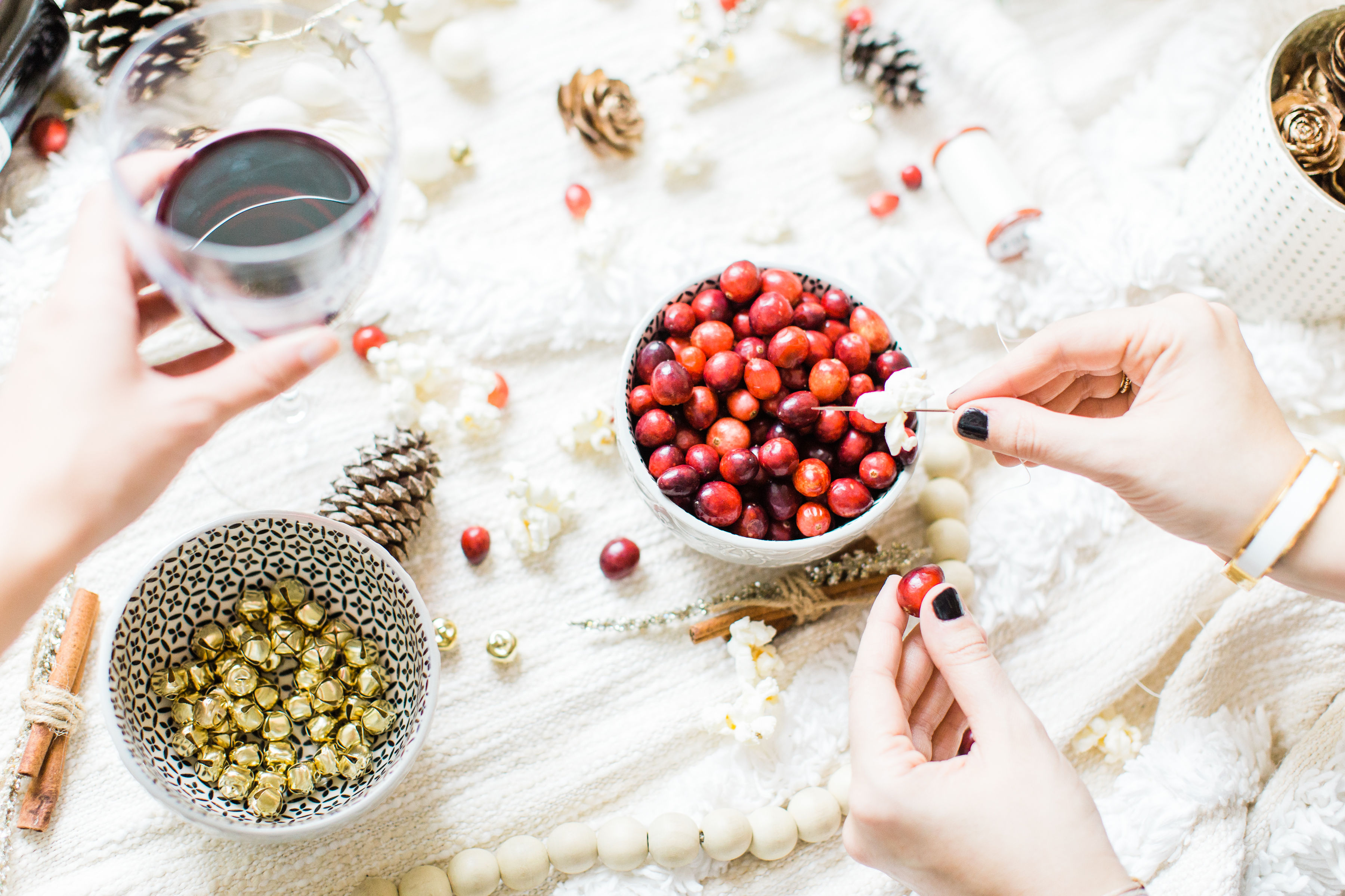 Looking for your next holiday party idea? Sip on wine and nibble on snacks while you make beautiful DIY holiday garlands with friends! (Bonus: The DIY holiday garland making party sets the stage for the perfect girls night in!) Click through for the details. #holidayparty #christmasparty #diychristmas #diyholidays #garland #holidaygarland #diyholidaygarland #diygarland #christmasgarland #holidaygirlsnight #christmasgirlsnight | glitterinc.com | @glitterinc