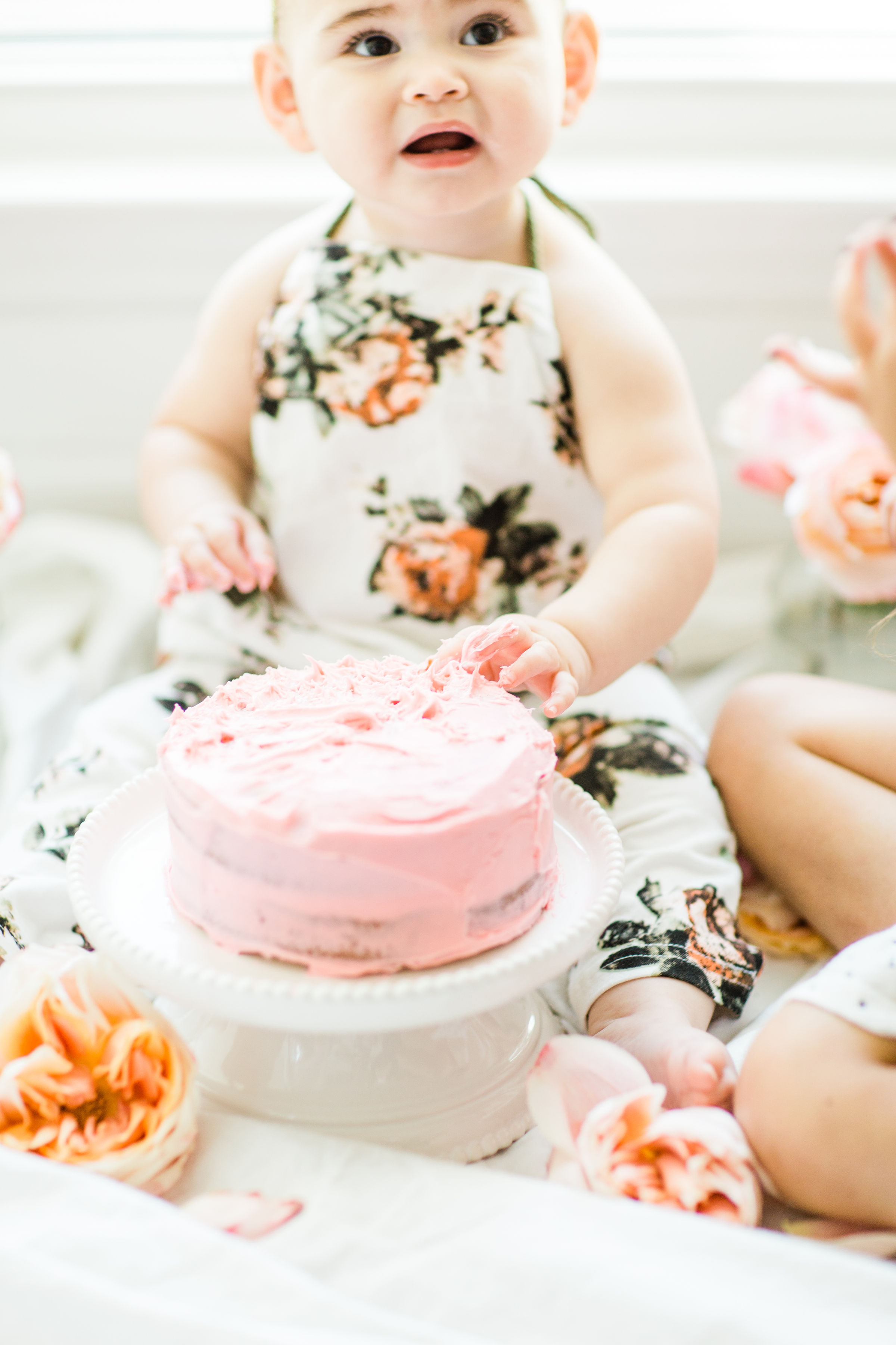 Looking for a little inspiration for baby's first birthday cake smash photo shoot? We're keeping it simple and adorable for Emmeline's cake smash, plus, we're sharing our favorite dairy-free vanilla crazy cake recipe! Click through for the details and #recipe. #firstbirthday #babybirthday #cakesmash #babycakesmash #cakesmashrecipe #firstbirthdaycake | glitterinc.com | @glitterinc