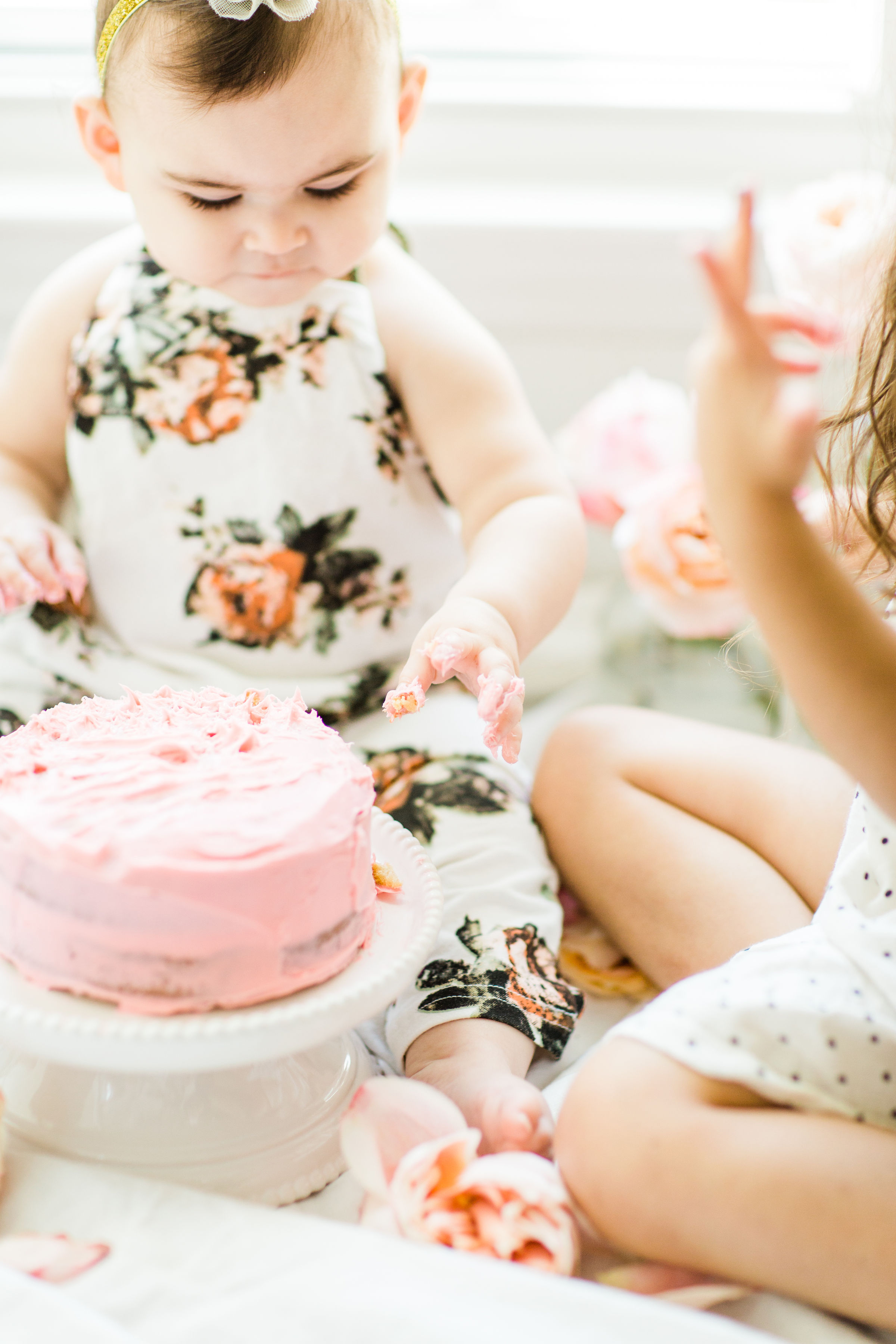 Looking for a little inspiration for baby's first birthday cake smash photo shoot? We're keeping it simple and adorable for Emmeline's cake smash, plus, we're sharing our favorite dairy-free vanilla crazy cake recipe! Click through for the details and #recipe. #firstbirthday #babybirthday #cakesmash #babycakesmash #cakesmashrecipe #firstbirthdaycake | glitterinc.com | @glitterinc