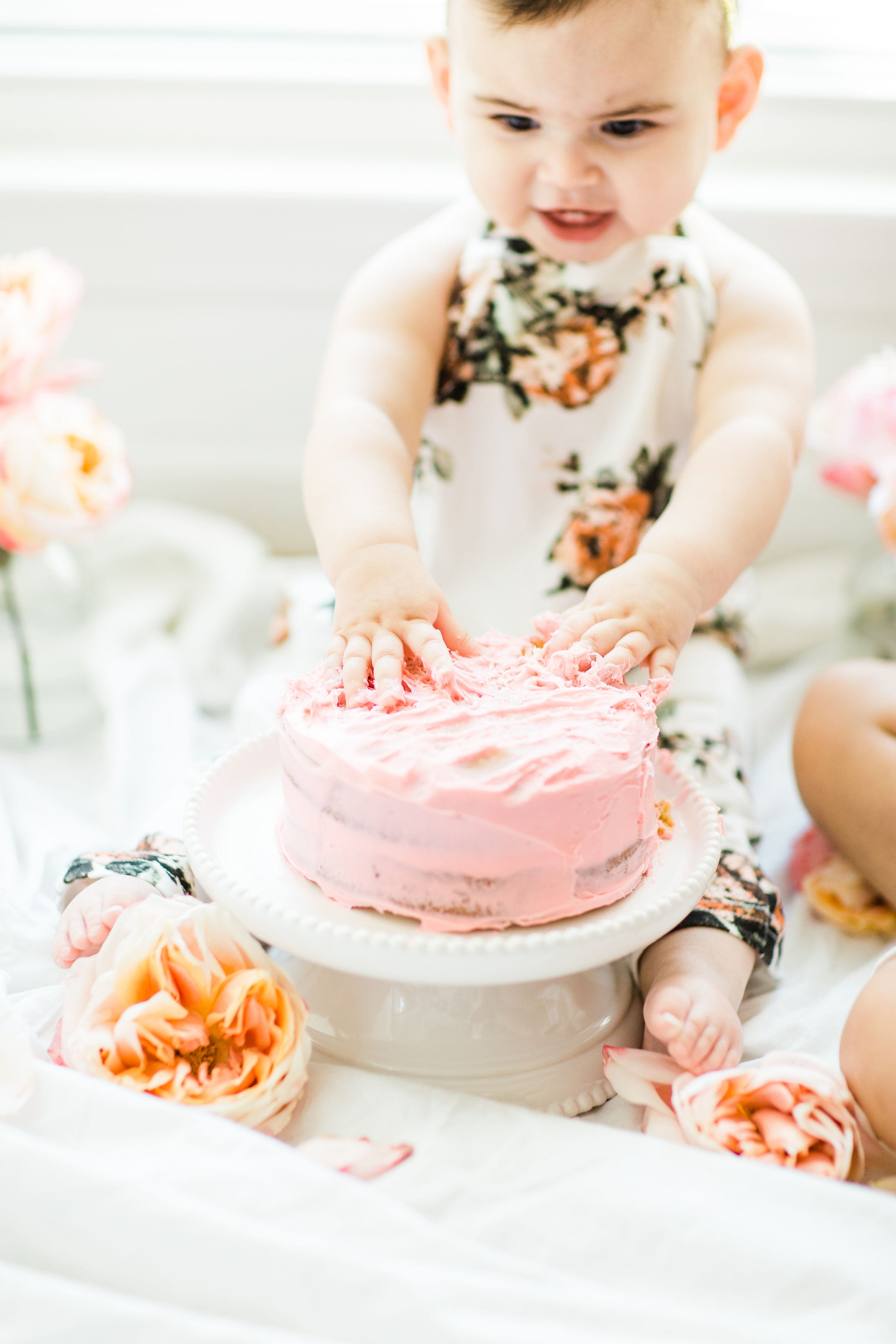 Looking for a little inspiration for baby's first birthday cake smash photo shoot? We're keeping it simple and adorable for Emmeline's cake smash, plus, we're sharing our favorite dairy-free vanilla crazy cake recipe! Click through for the details and #recipe. #firstbirthday #babybirthday #cakesmash #babycakesmash #cakesmashrecipe #firstbirthdaycake | glitterinc.com | @glitterinc