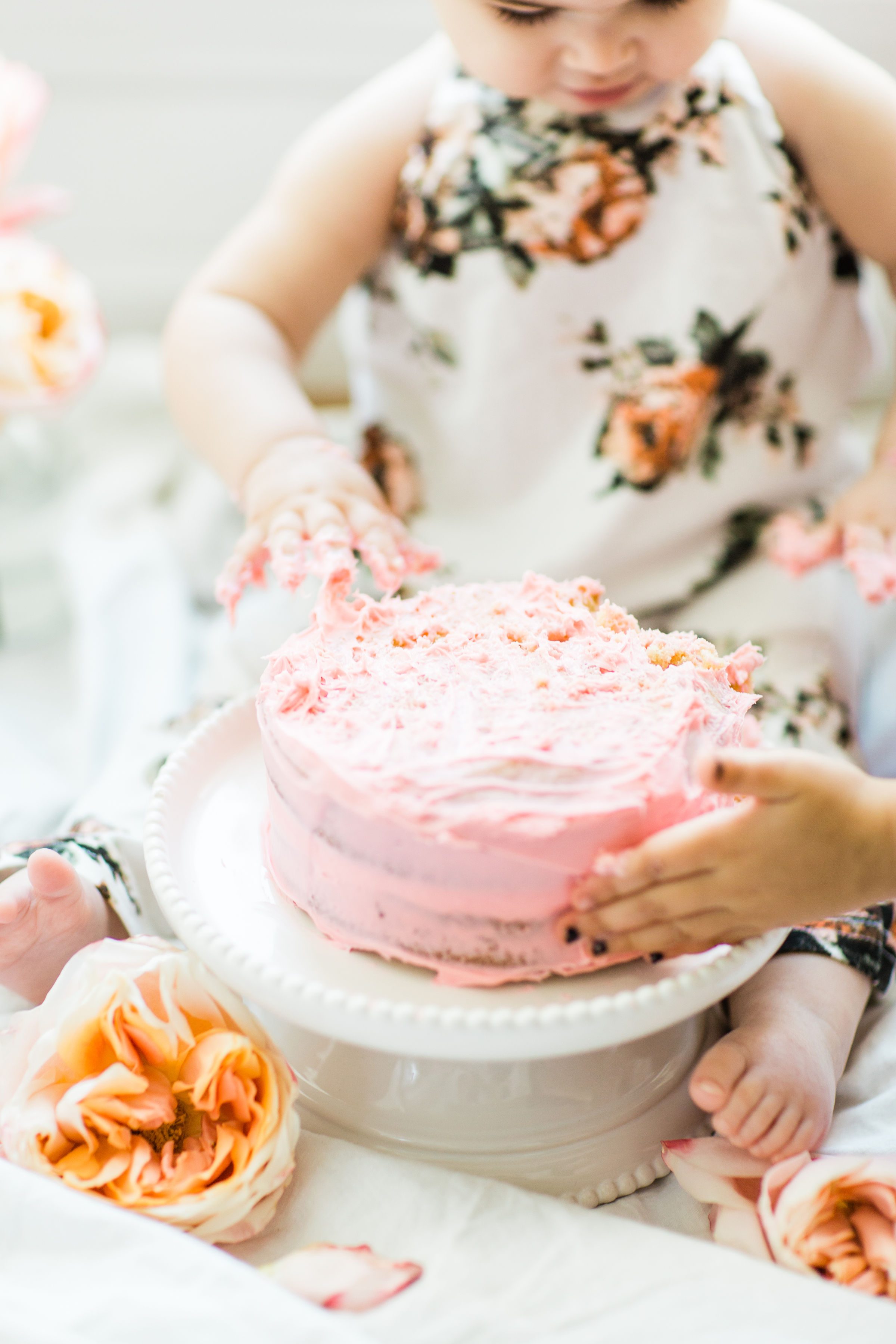 Looking for a little inspiration for baby's first birthday cake smash photo shoot? We're keeping it simple and adorable for Emmeline's cake smash, plus, we're sharing our favorite dairy-free vanilla crazy cake recipe! Click through for the details and #recipe. #firstbirthday #babybirthday #cakesmash #babycakesmash #cakesmashrecipe #firstbirthdaycake | glitterinc.com | @glitterinc