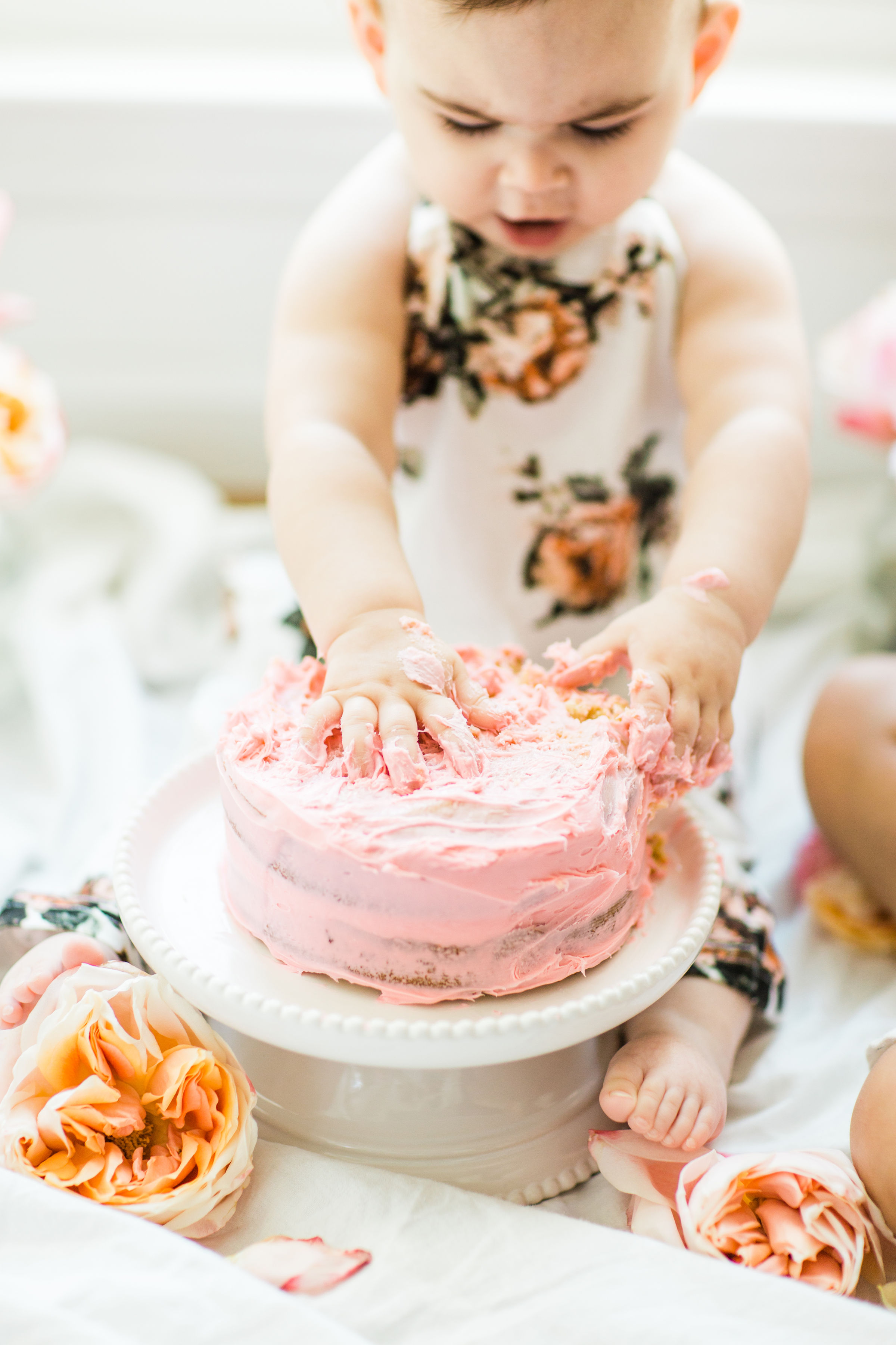 Looking for a little inspiration for baby's first birthday cake smash photo shoot? We're keeping it simple and adorable for Emmeline's cake smash, plus, we're sharing our favorite dairy-free vanilla crazy cake recipe! Click through for the details and #recipe. #firstbirthday #babybirthday #cakesmash #babycakesmash #cakesmashrecipe #firstbirthdaycake | glitterinc.com | @glitterinc