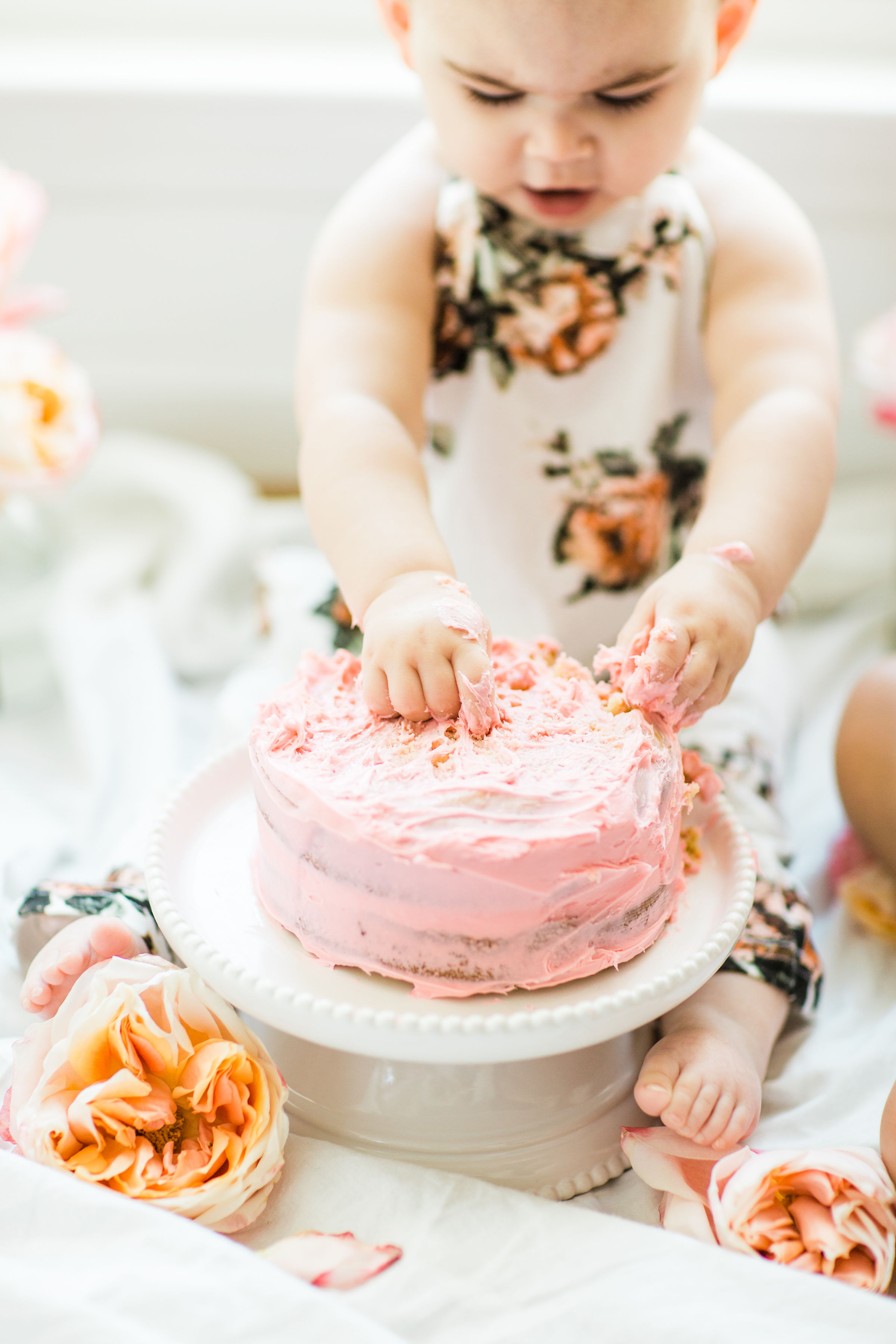 Looking for a little inspiration for baby's first birthday cake smash photo shoot? We're keeping it simple and adorable for Emmeline's cake smash, plus, we're sharing our favorite dairy-free vanilla crazy cake recipe! Click through for the details and #recipe. #firstbirthday #babybirthday #cakesmash #babycakesmash #cakesmashrecipe #firstbirthdaycake | glitterinc.com | @glitterinc