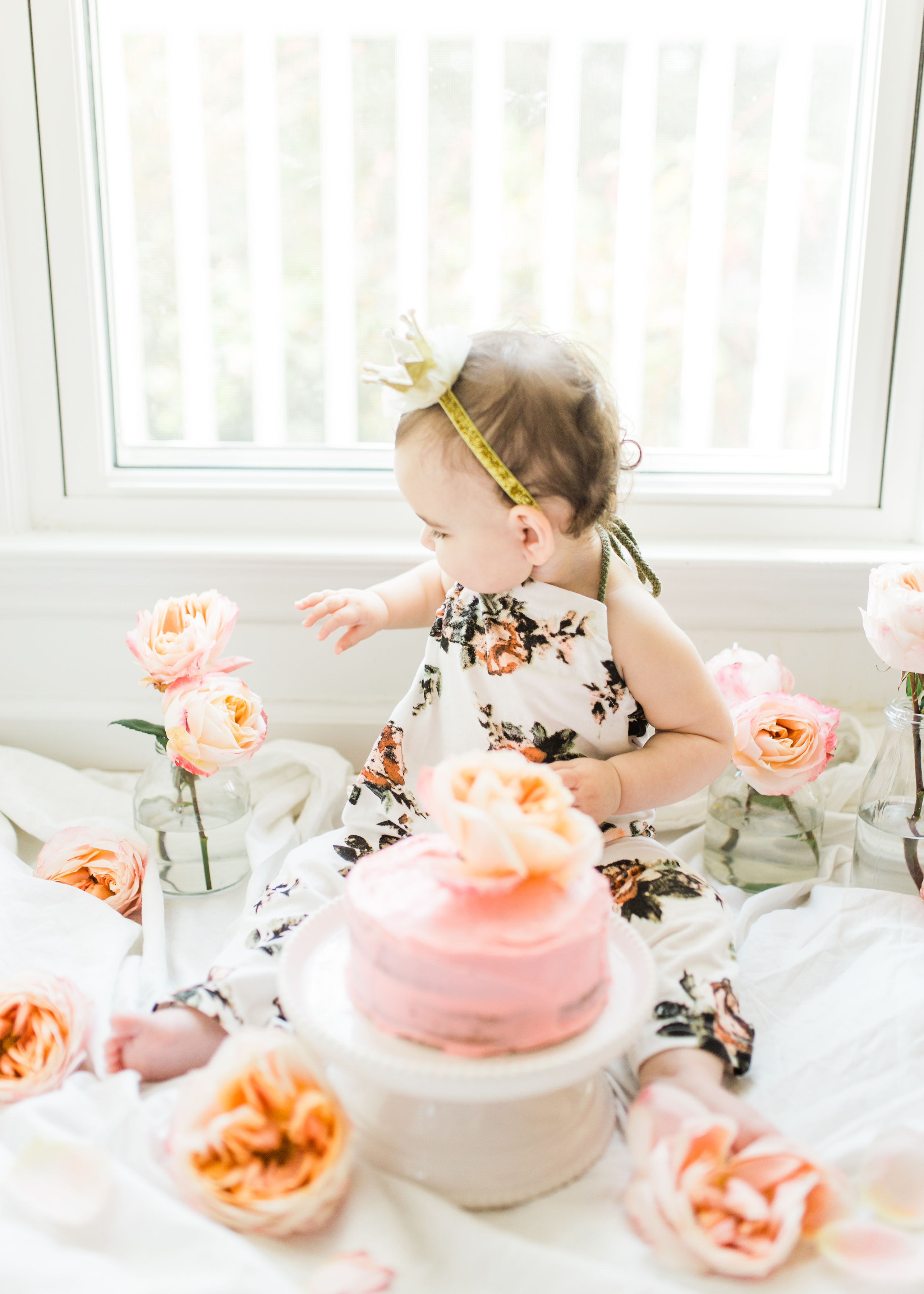 Looking for a little inspiration for baby's first birthday cake smash photo shoot? We're keeping it simple and adorable for Emmeline's cake smash, plus, we're sharing our favorite dairy-free vanilla crazy cake recipe! Click through for the details and #recipe. #firstbirthday #babybirthday #cakesmash #babycakesmash #cakesmashrecipe #firstbirthdaycake | glitterinc.com | @glitterinc