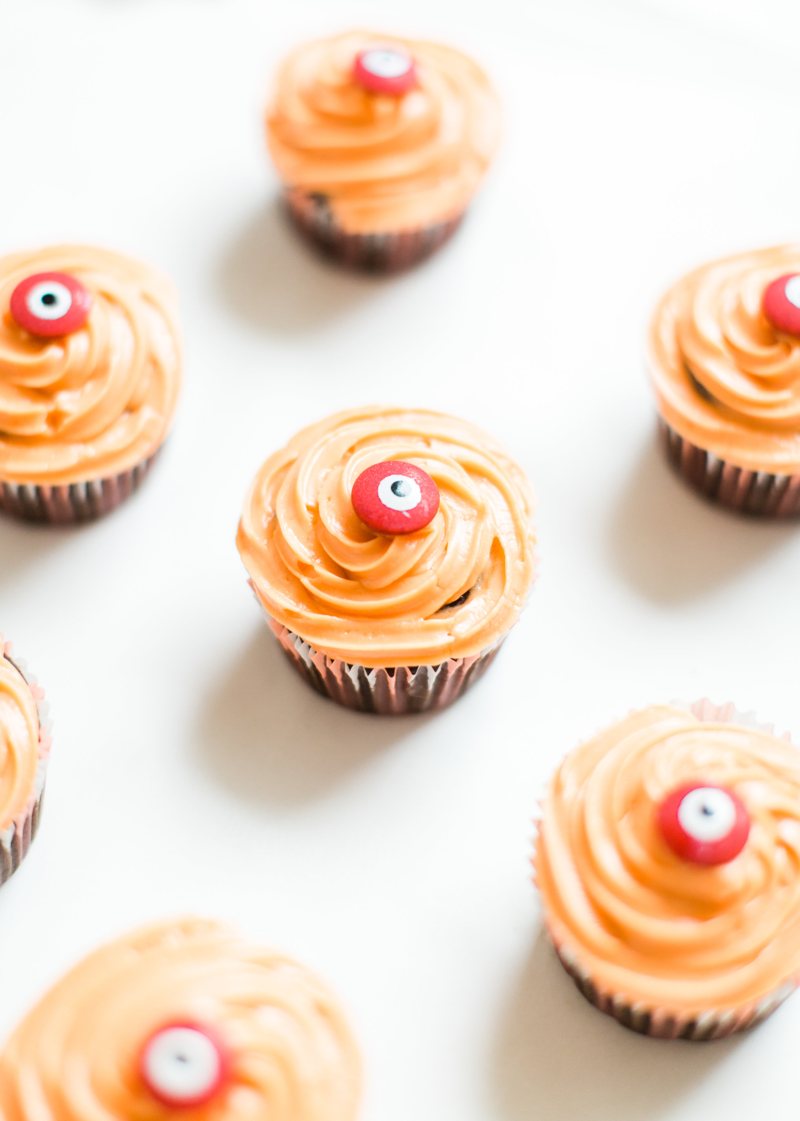 Make these absolutely adorable haunted Halloween eyeball chocolate cupcakes with our favorite easy crazy cake recipe. These easy-to-make cupcakes are perfect for your next spooky Halloween party! Click through for the #recipe.  #halloweencupcakes #crazycake #crazycakecupcakes #halloweendessert #halloweendiy #diy #eyeballcupcakes #spookycupcakes #halloweencake | glitterinc.com | @glitterinc