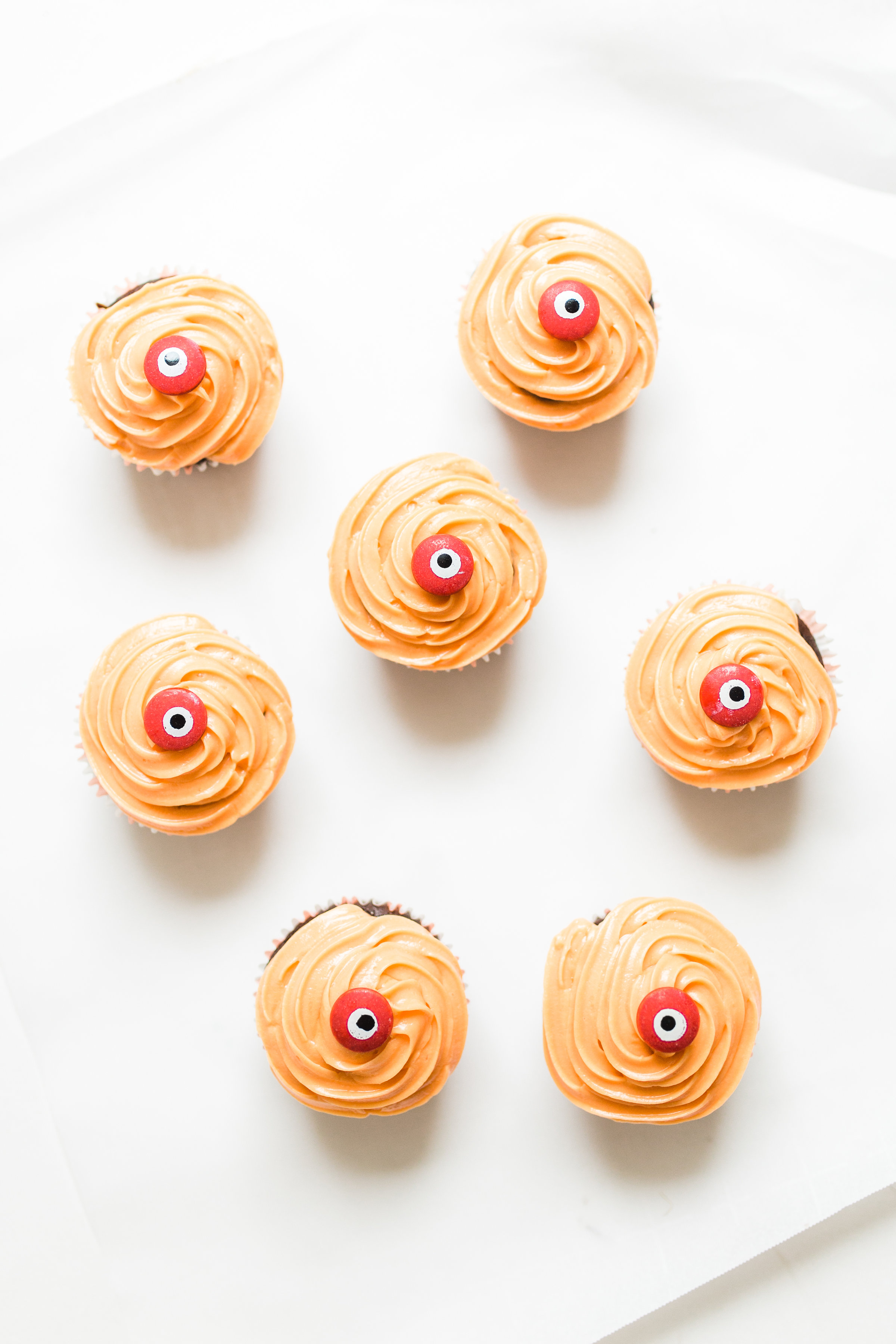 Make these absolutely adorable haunted Halloween eyeball chocolate cupcakes with our favorite easy crazy cake recipe. These easy-to-make cupcakes are perfect for your next spooky Halloween party! #halloween #halloweencupcakes #crazycake #crazycakecupcakes #halloweendessert #halloweendiy #diy #eyeballcupcakes #spookycupcakes #halloweencake | glitterinc.com | @glitterinc