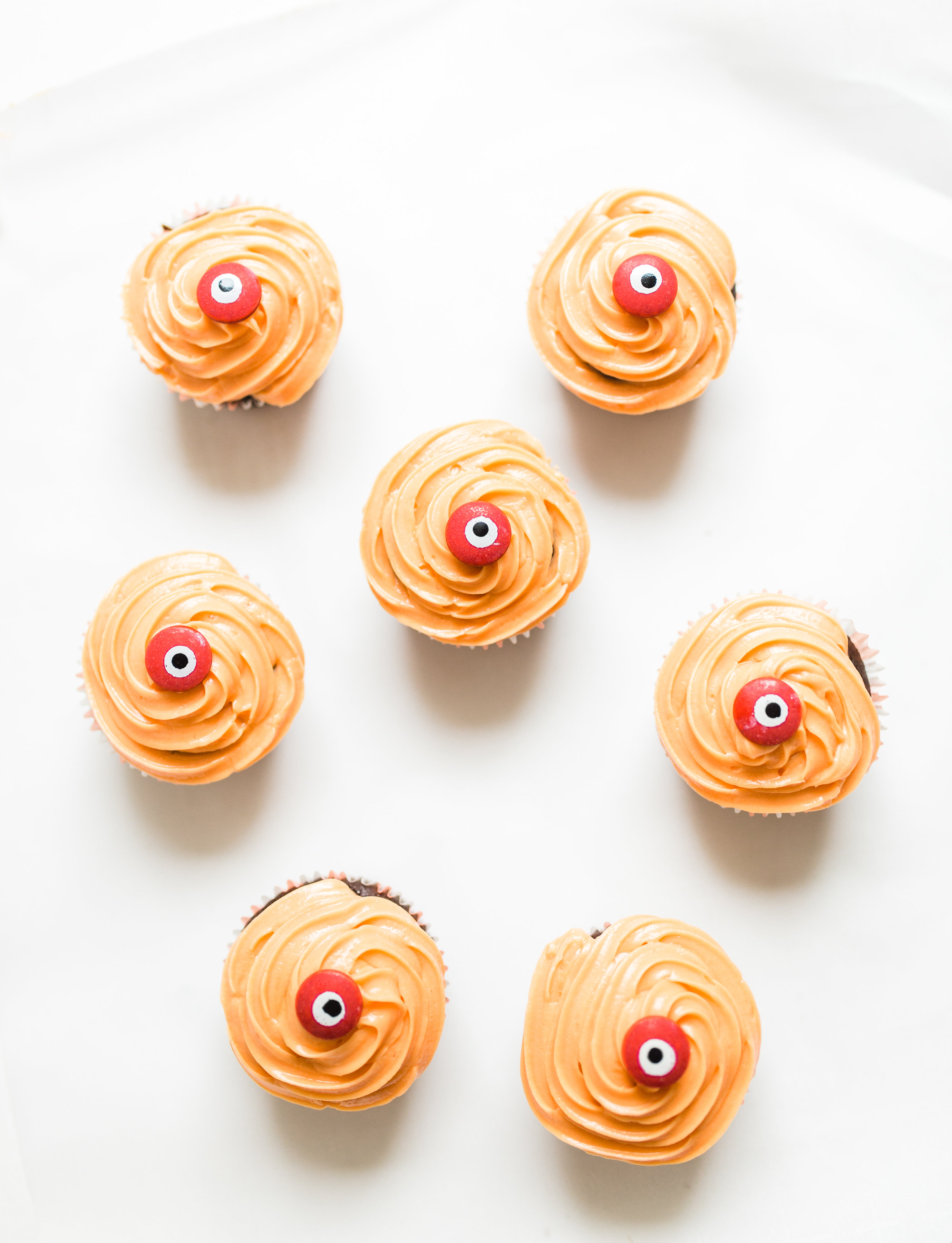 Make these absolutely adorable haunted Halloween eyeball chocolate cupcakes with our favorite easy crazy cake recipe. These easy-to-make cupcakes are perfect for your next spooky Halloween party! Click through for the #recipe. #halloween #halloweencupcakes #crazycake #crazycakecupcakes #diy #eyeballcupcakes #spookycupcakes #halloweencake | glitterinc.com | @glitterinc