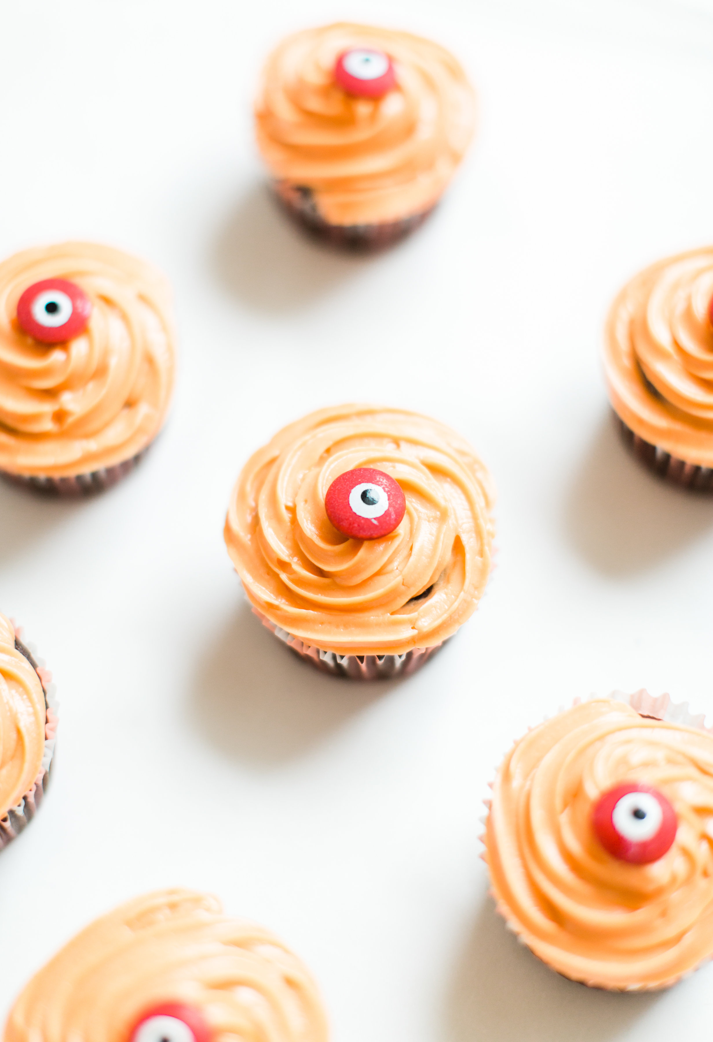 Make these absolutely adorable haunted Halloween eyeball chocolate cupcakes with our favorite easy crazy cake recipe. These easy-to-make cupcakes are perfect for your next spooky Halloween party! Click through for the #recipe. #halloween #halloweencupcakes #crazycake #crazycakecupcakes #halloweendessert #halloweendiy  #eyeballcupcakes #spookycupcakes #halloweencake | glitterinc.com | @glitterinc