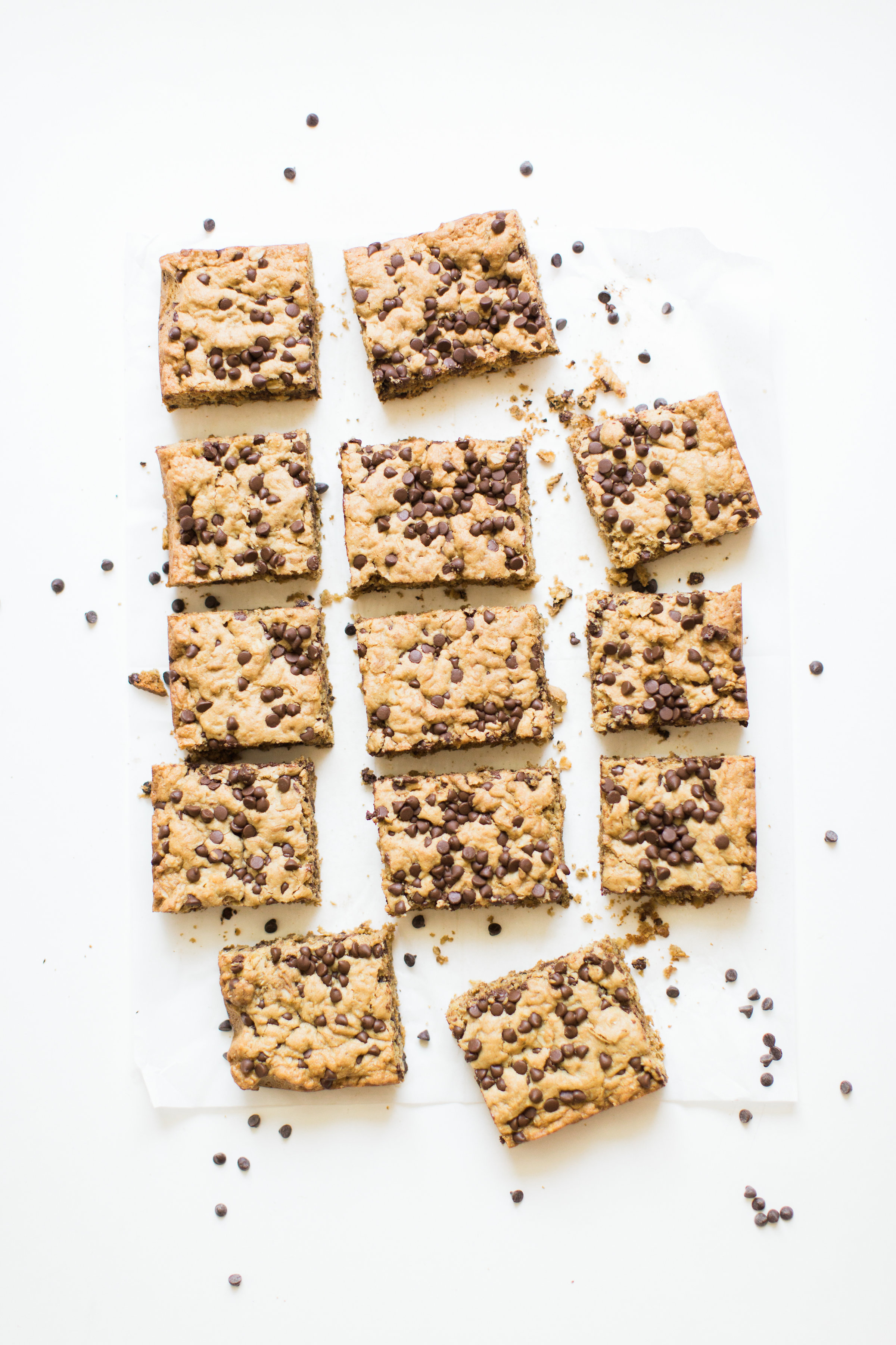 Delicious chocolate chip oatmeal cookies made extra simple by baking them up in a big batch of bars, these super moist chocolate chip oatmeal cookie bars are a favorite of our whole family, and for good reason! #oatmealcookies #oatmealcookiebars #cookiebars #cookierecipe #oatmealcookierecipe #dairyfree | glitterinc.com | @glitterinc