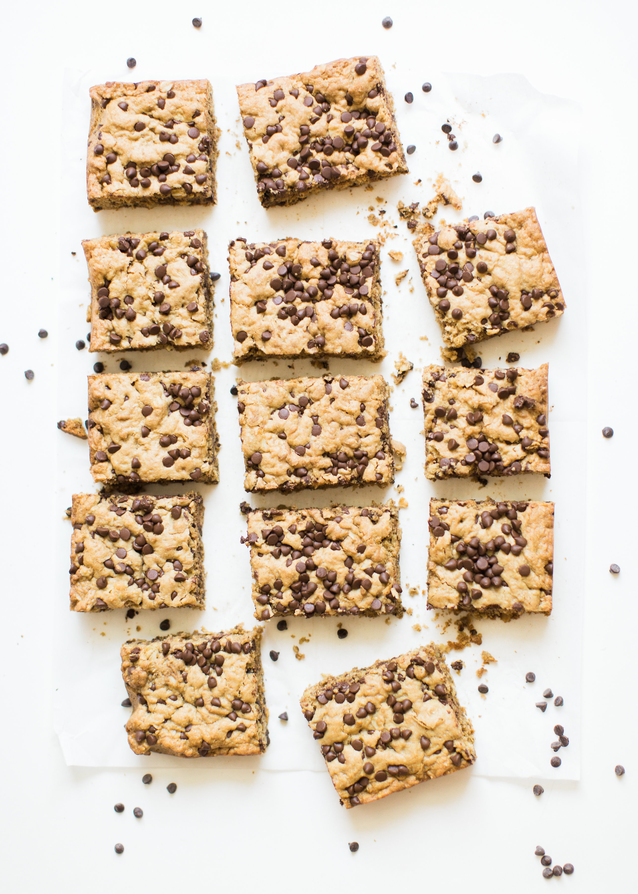 Delicious chocolate chip oatmeal cookies made extra simple by baking them up in a big batch of bars, these super moist chocolate chip oatmeal cookie bars are a favorite of our whole family, and for good reason! Click through for the #recipe. #oatmealcookies #oatmealcookiebars #cookiebars  #oatmealcookierecipe #dairyfree | glitterinc.com | @glitterinc