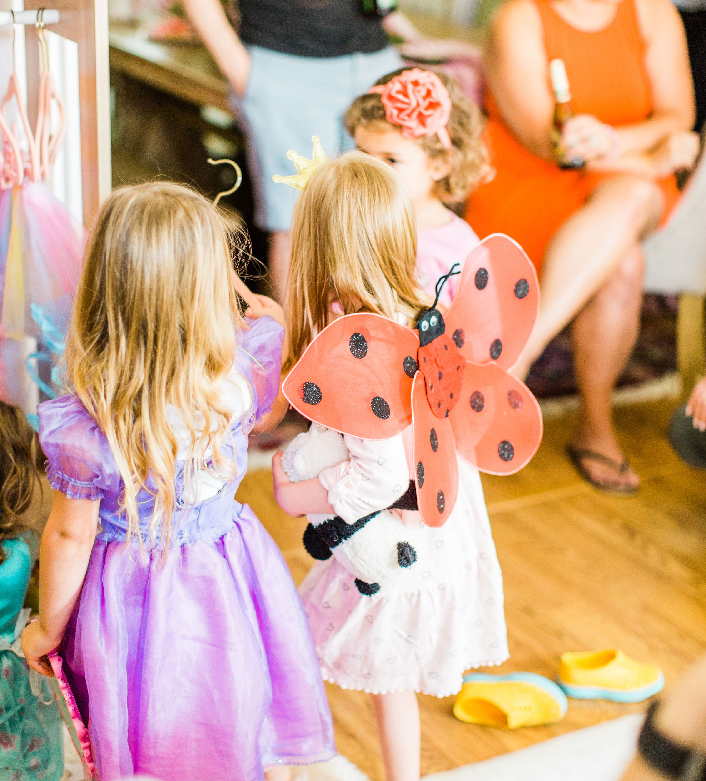 Ready to throw one beautiful and memorable princess pajama birthday party? Have we got some inspiration for you! We turned our living room into one giant slumber party and covered every available space with sheets, pillows, and blankets, plus gorgeous pink florals, a cozy tent lounge, a DIY magic mirror decorating activity for the kids, a dress-up station with crowns, wands, and wings, a pin the tail on the unicorn game, and so much more. Click through for the party details. #party #pajamaparty #princessparty #dressup | glitterinc.com | @glitterinc