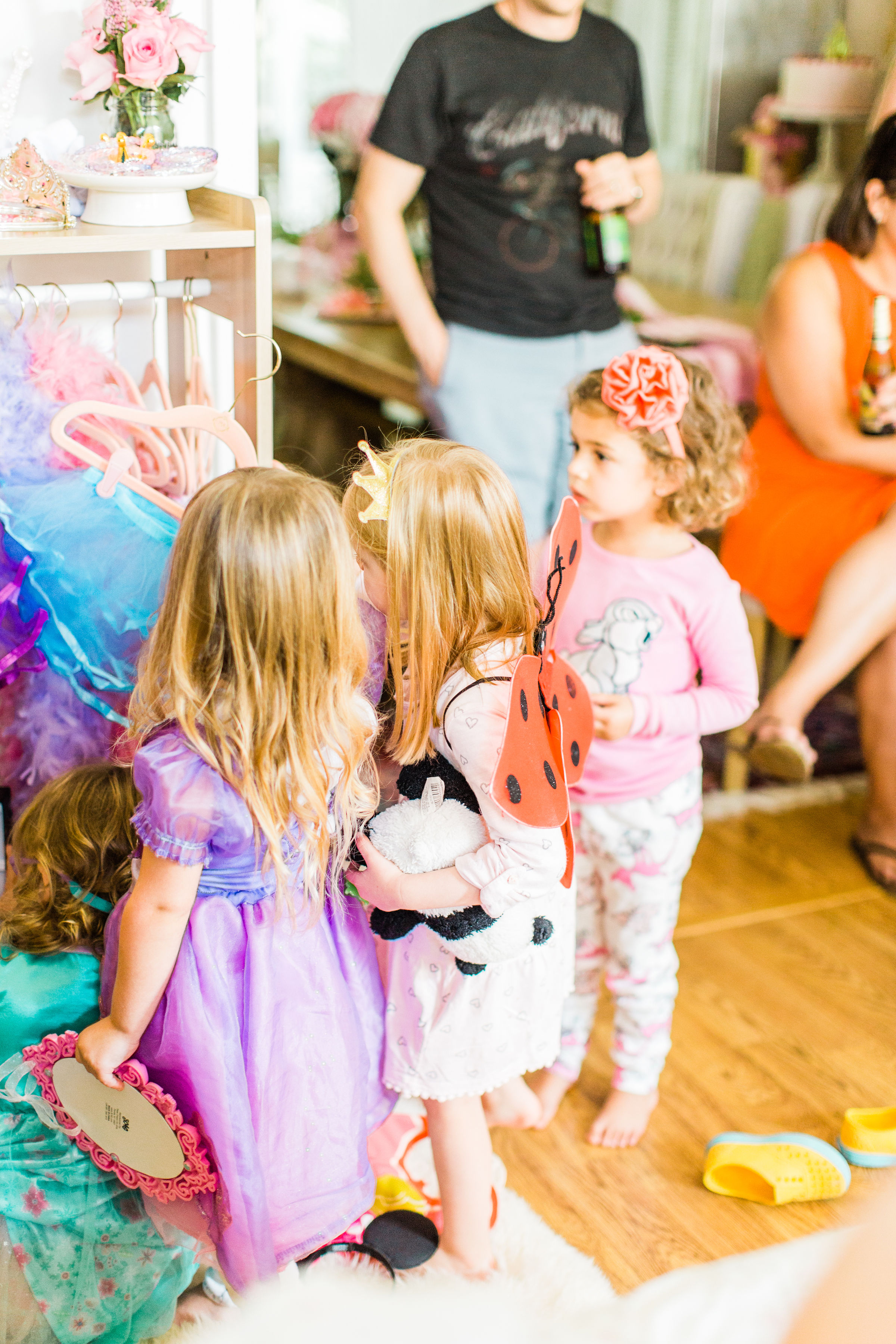 Ready to throw one beautiful and memorable princess pajama birthday party? Have we got some inspiration for you! We turned our living room into one giant slumber party and covered every available space with sheets, pillows, and blankets, plus gorgeous pink florals, a cozy tent lounge, a DIY magic mirror decorating activity for the kids, a dress-up station with crowns, wands, and wings, a pin the tail on the unicorn game, and so much more. Click through for the party details. #party #pajamaparty #princessparty #dressup | glitterinc.com | @glitterinc