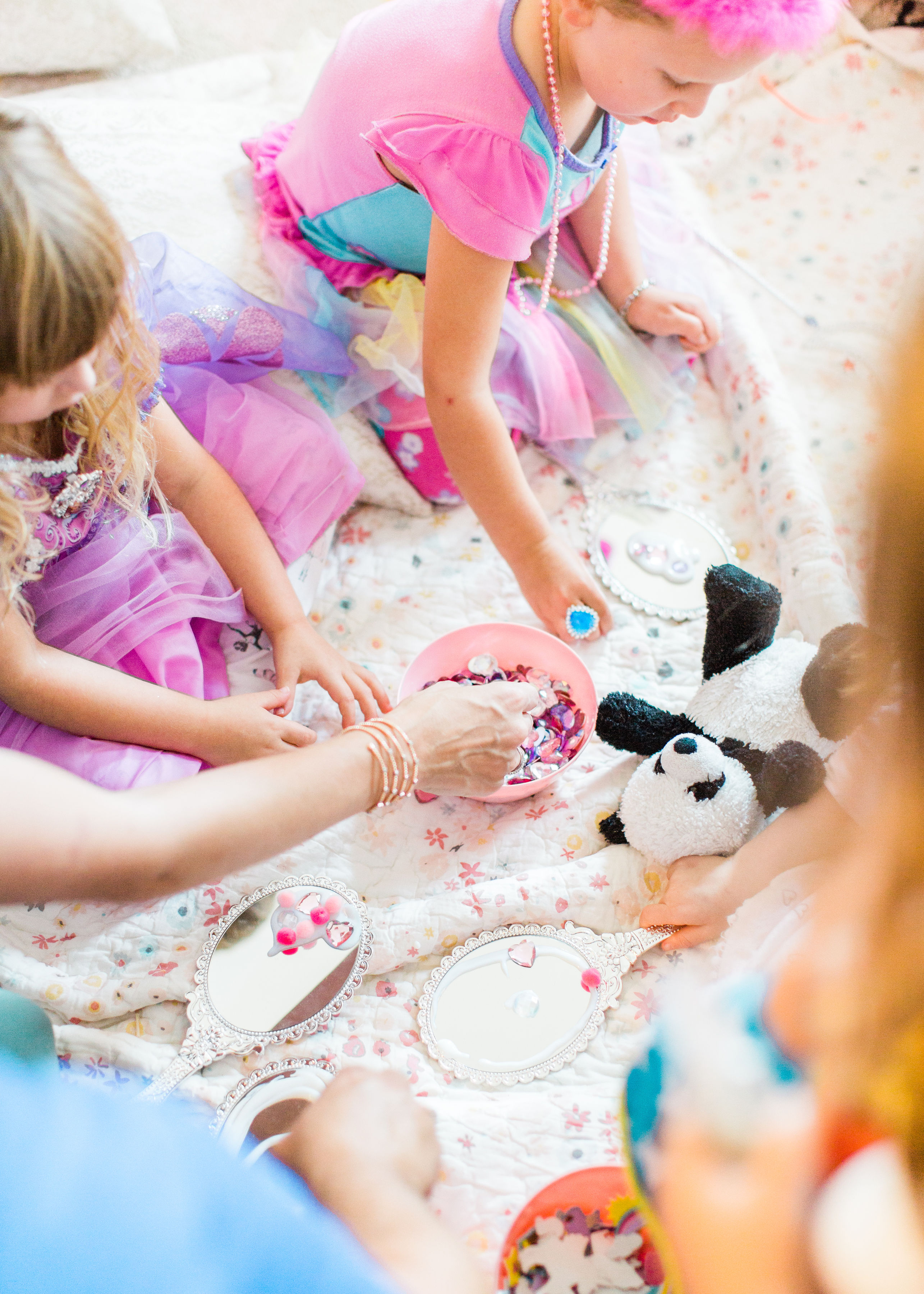 Ready to throw one beautiful and memorable princess pajama birthday party? Have we got some inspiration for you! We turned our living room into one giant slumber party and covered every available space with sheets, pillows, and blankets, plus gorgeous pink florals, a cozy tent lounge, a DIY magic mirror decorating activity for the kids, a dress-up station with crowns, wands, and wings, a pin the tail on the unicorn game, and so much more. Click through for the party details. #party #pajamaparty #princessparty #dressup | glitterinc.com | @glitterinc