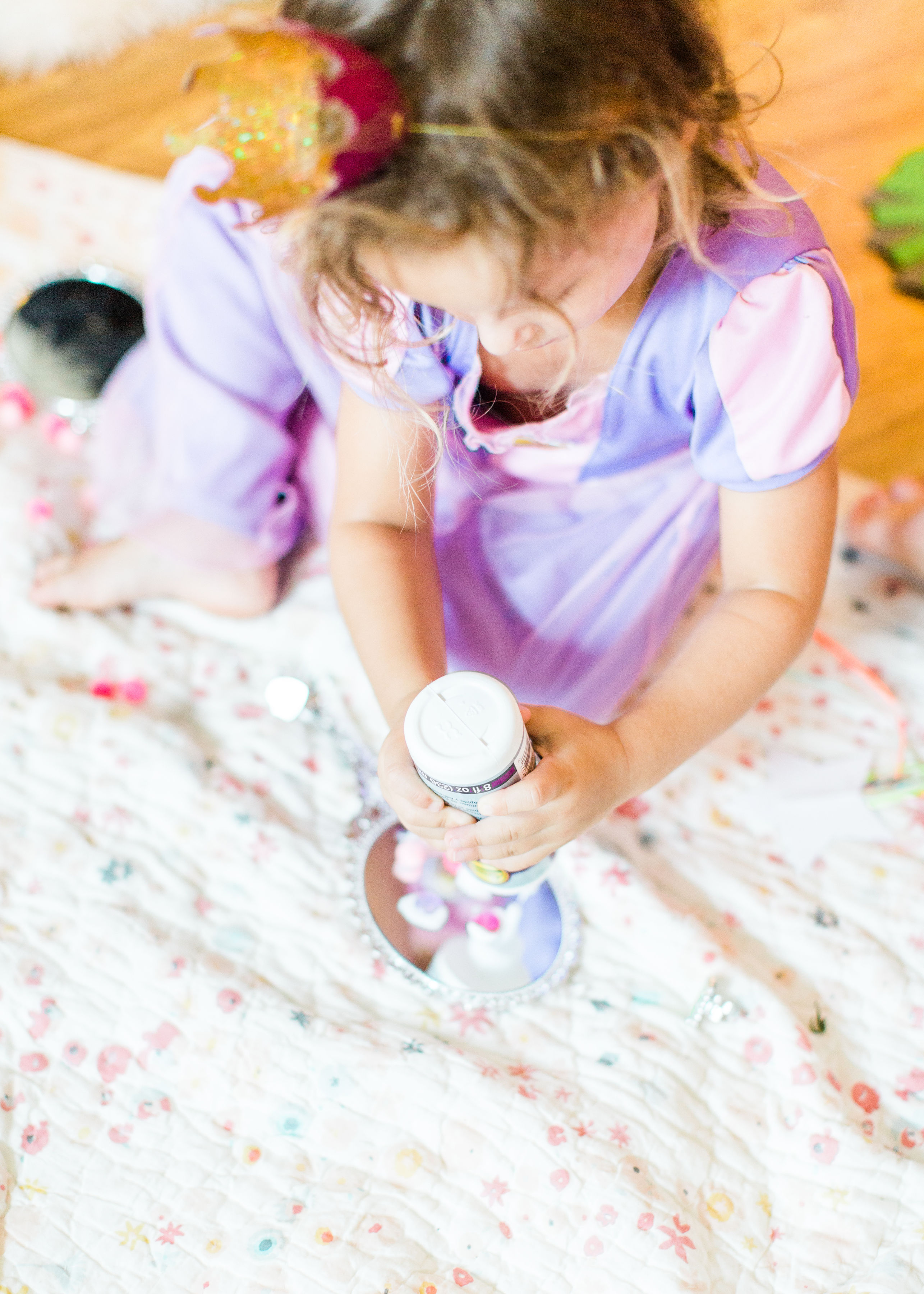 Ready to throw one beautiful and memorable princess pajama birthday party? Have we got some inspiration for you! We turned our living room into one giant slumber party and covered every available space with sheets, pillows, and blankets, plus gorgeous pink florals, a cozy tent lounge, a DIY magic mirror decorating activity for the kids, a dress-up station with crowns, wands, and wings, a pin the tail on the unicorn game, and so much more. Click through for the party details. #party #pajamaparty #princessparty #dressup | glitterinc.com | @glitterinc
