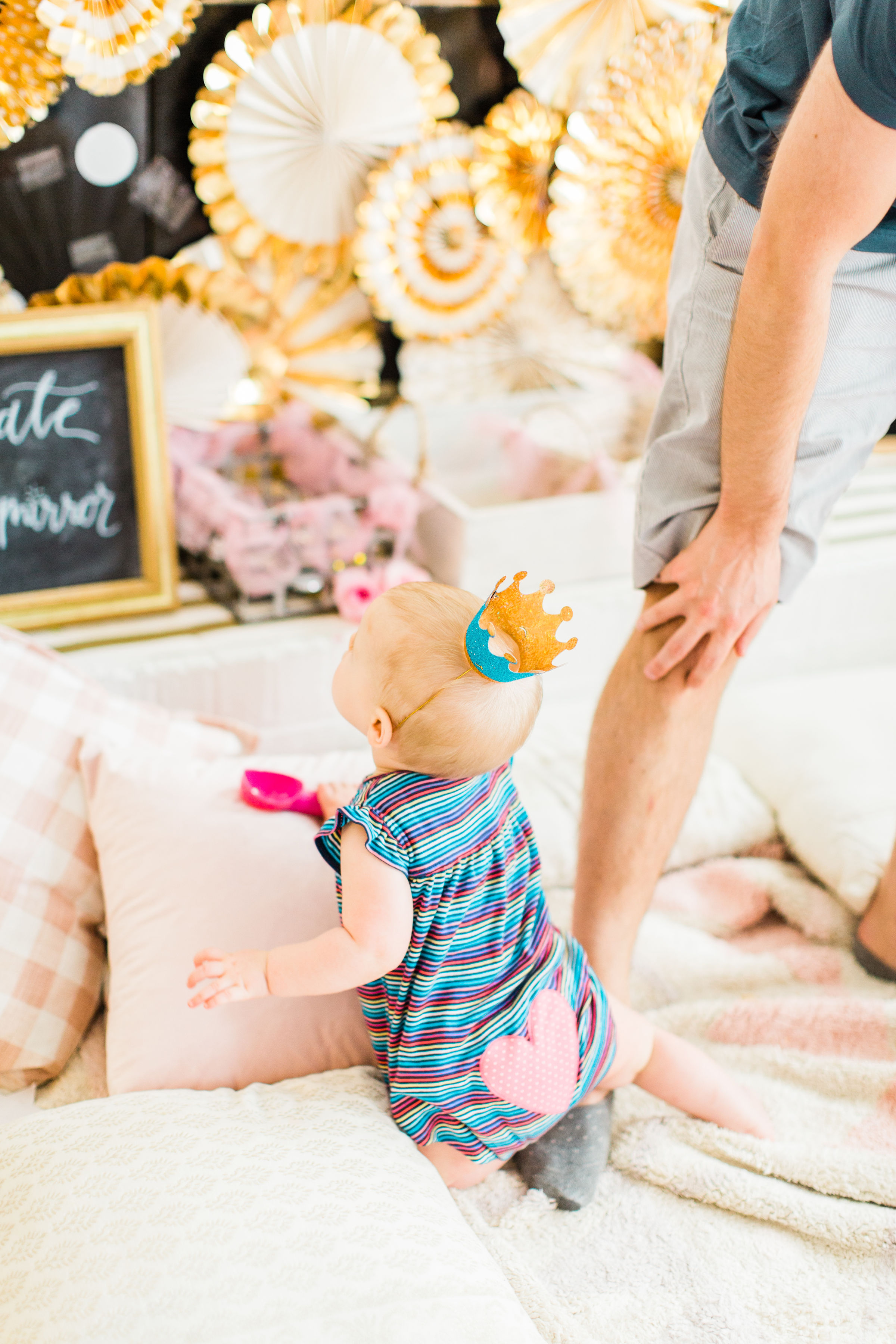 Ready to throw one beautiful and memorable princess pajama birthday party? Have we got some inspiration for you! We turned our living room into one giant slumber party and covered every available space with sheets, pillows, and blankets, plus gorgeous pink florals, a cozy tent lounge, a DIY magic mirror decorating activity for the kids, a dress-up station with crowns, wands, and wings, a pin the tail on the unicorn game, and so much more. Click through for the party details. #party #pajamaparty #princessparty #dressup | glitterinc.com | @glitterinc