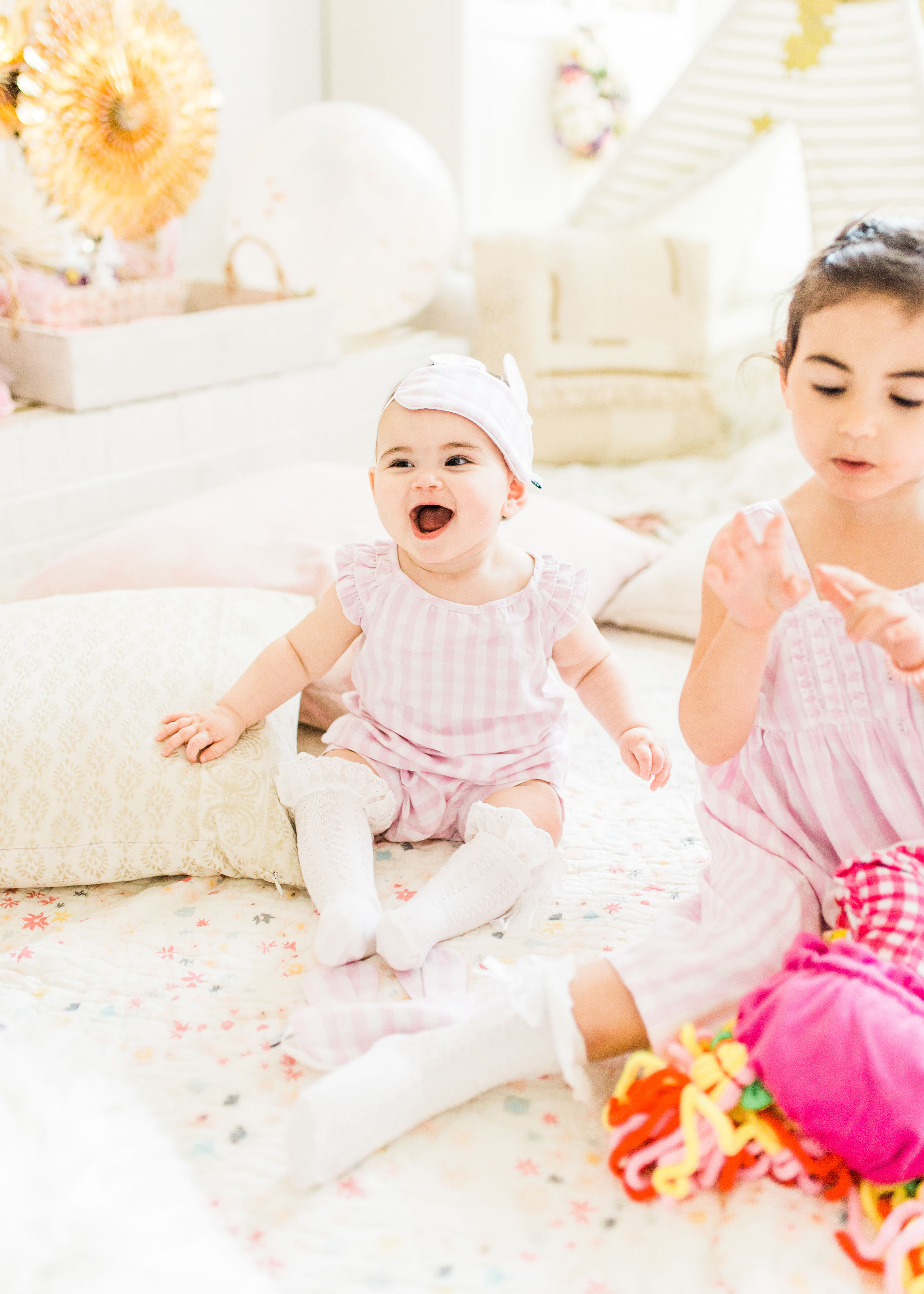 Ready to throw one beautiful and memorable princess pajama birthday party? Have we got some inspiration for you! We turned our living room into one giant slumber party and covered every available space with sheets, pillows, and blankets, plus gorgeous pink florals, a cozy tent lounge, a DIY magic mirror decorating activity for the kids, a dress-up station with crowns, wands, and wings, a pin the tail on the unicorn game, and so much more. Click through for the party details. #party #pajamaparty #princessparty #dressup | glitterinc.com | @glitterinc