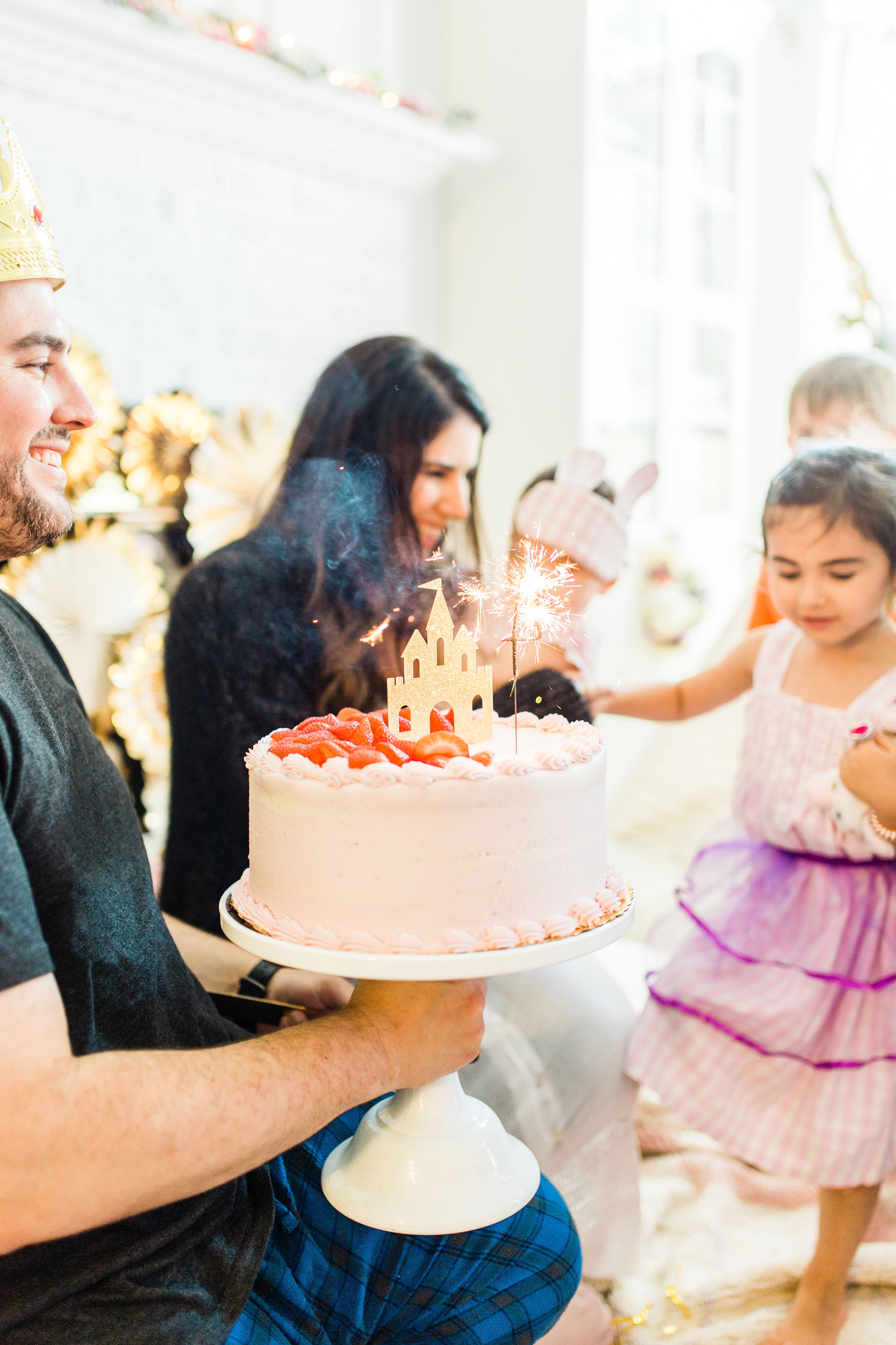 Ready to throw one beautiful and memorable princess pajama birthday party? Have we got some inspiration for you! We turned our living room into one giant slumber party and covered every available space with sheets, pillows, and blankets, plus gorgeous pink florals, a cozy tent lounge, a DIY magic mirror decorating activity for the kids, a dress-up station with crowns, wands, and wings, a pin the tail on the unicorn game, and so much more. Click through for the party details. #party #pajamaparty #princessparty #dressup | glitterinc.com | @glitterinc