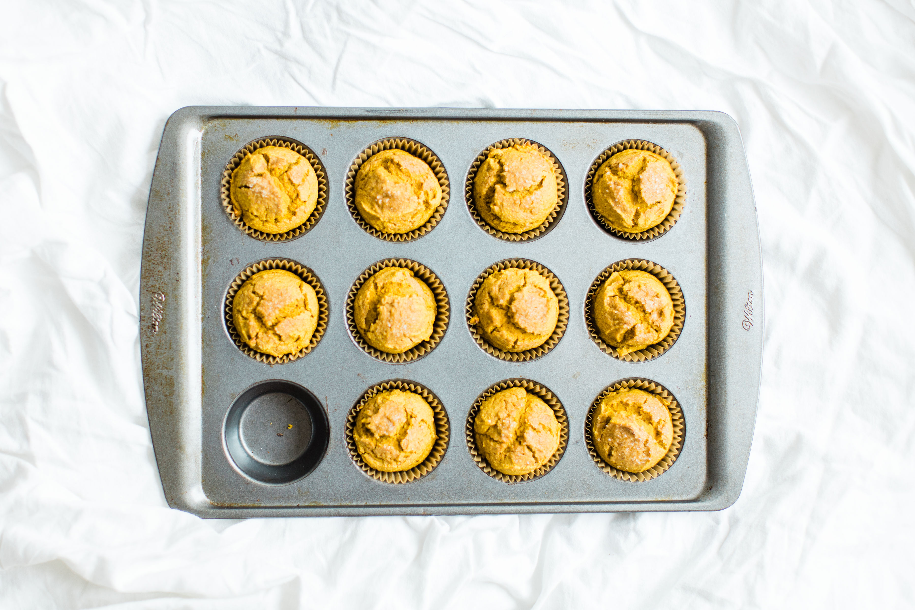 Say hello to your new favorite healthy pumpkin muffins! Full of that fall pumpkin goodness, these naturally gluten-free, dairy-free, sweetened with maple syrup, muffins, are where it's at! Click through for the recipe. #pumpkinmuffins #healthypumpkinmuffins #fall #falldessert #fallmuffin #thanksgiving #glutenfree #dairyfree #lowsugar | glitterinc.com | @glitterinc