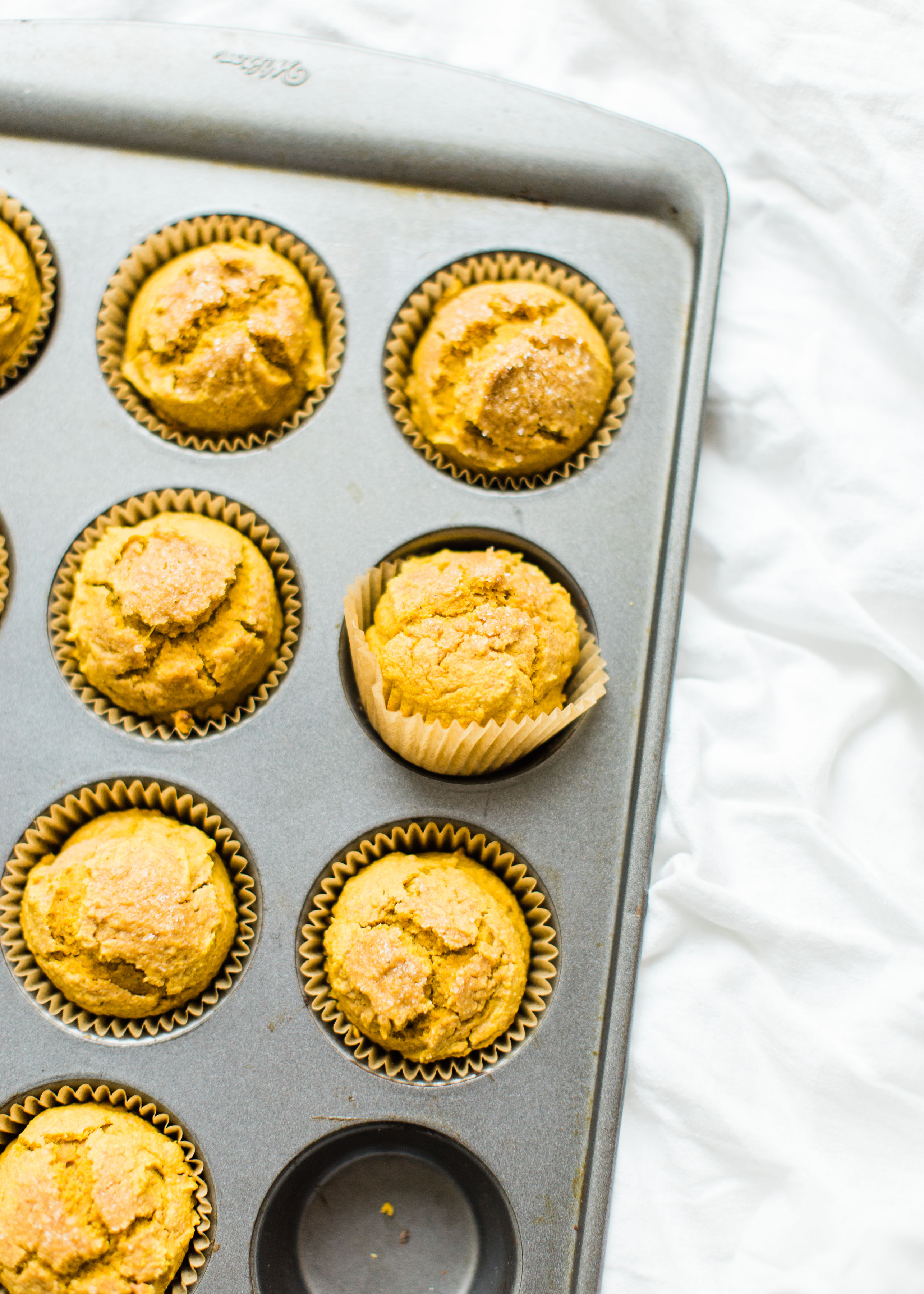 Say hello to your new favorite healthy pumpkin muffins! Full of that fall pumpkin goodness, these naturally gluten-free, dairy-free, sweetened with maple syrup, muffins, are where it's at! Click through for the recipe. #pumpkinmuffins #healthypumpkinmuffins #fall #falldessert #fallmuffin #thanksgiving #glutenfree #dairyfree | glitterinc.com | @glitterinc