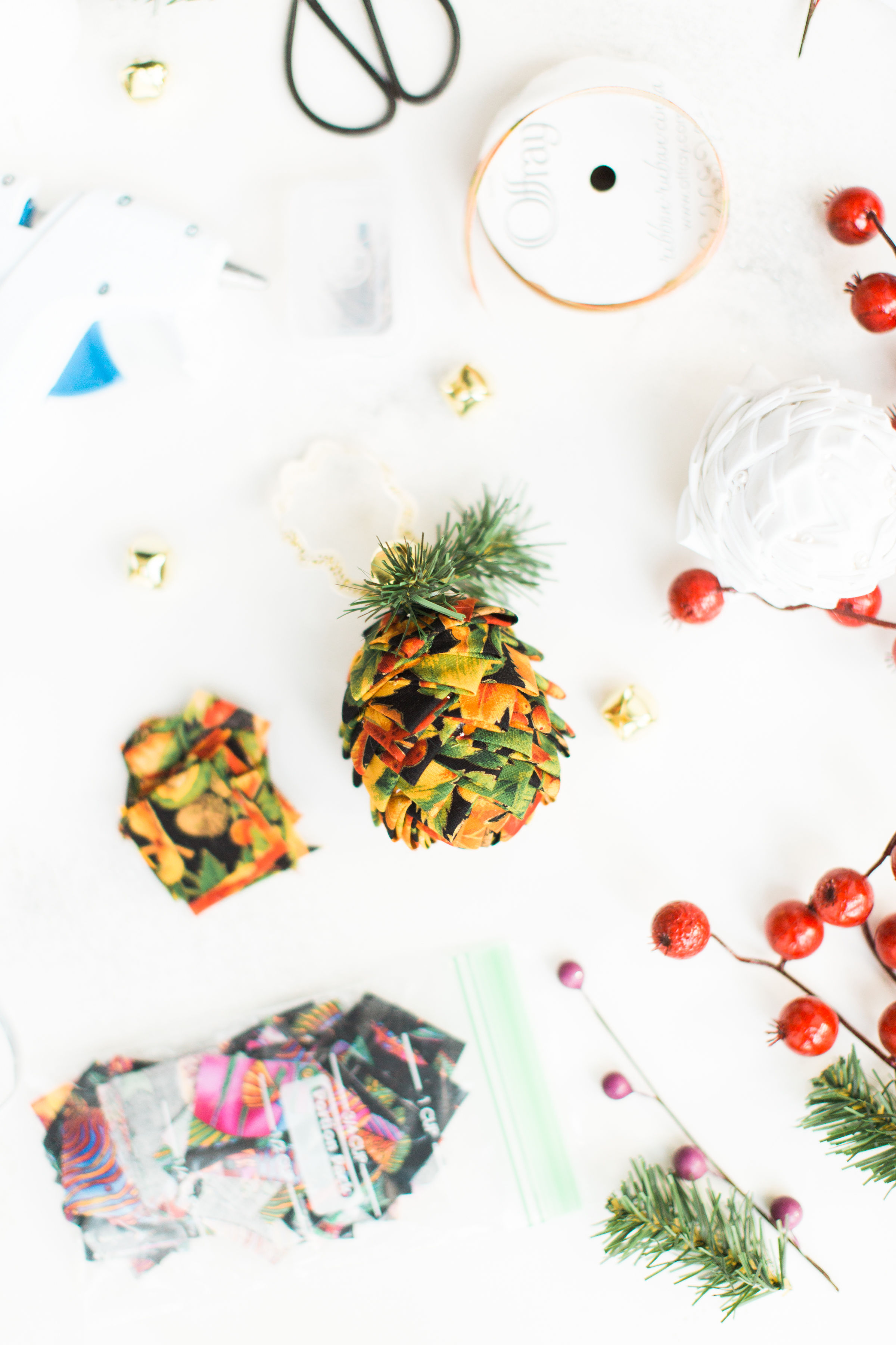 Looking for a fun Christmas craft to make this holiday season? DIY folded fabric pinecones make the prettiest ornaments, are perfect as gift toppers, and use up leftover fabric scraps - no sewing required. Click through for the details. #diyfabricpinecones #christmascraft #holidaycraft #holidaydiy #christmasdiy  | glitterinc.com | @glitterinc