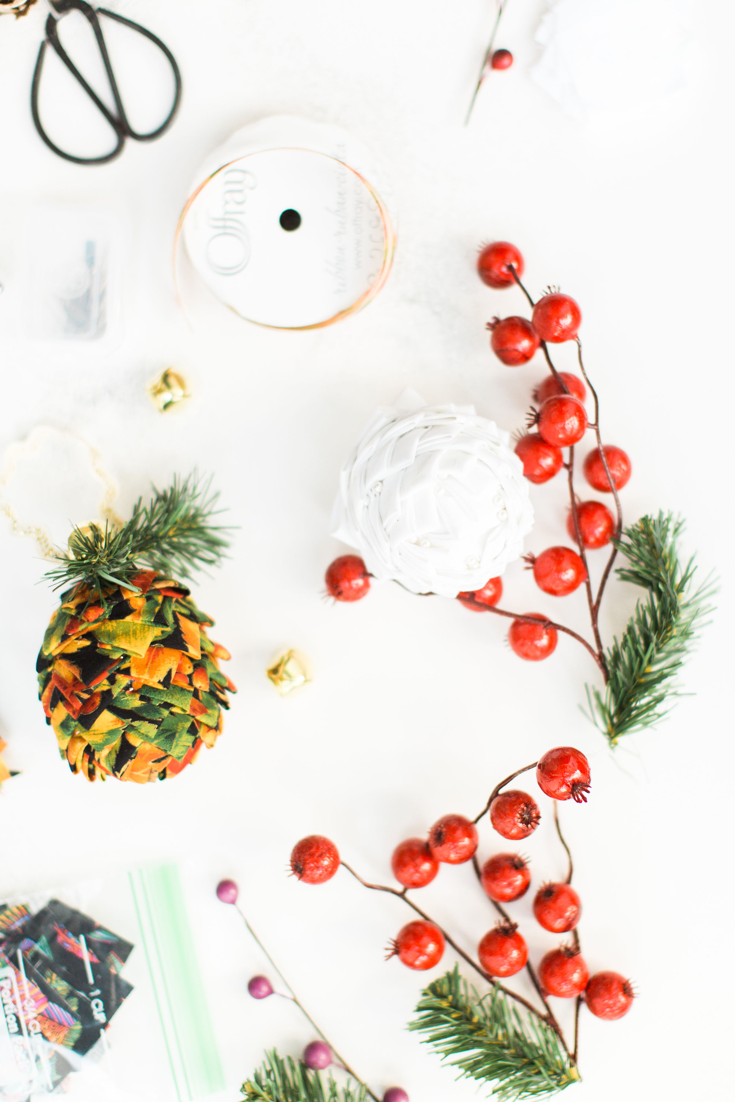 Looking for a fun Christmas craft to make this holiday season? DIY folded fabric pinecones make the prettiest ornaments, are perfect as gift toppers, and use up leftover fabric scraps - no sewing required. Click through for the details. #diyfabricpinecones #christmascraft #holidaycraft #christmasdiy #nosew | glitterinc.com | @glitterinc