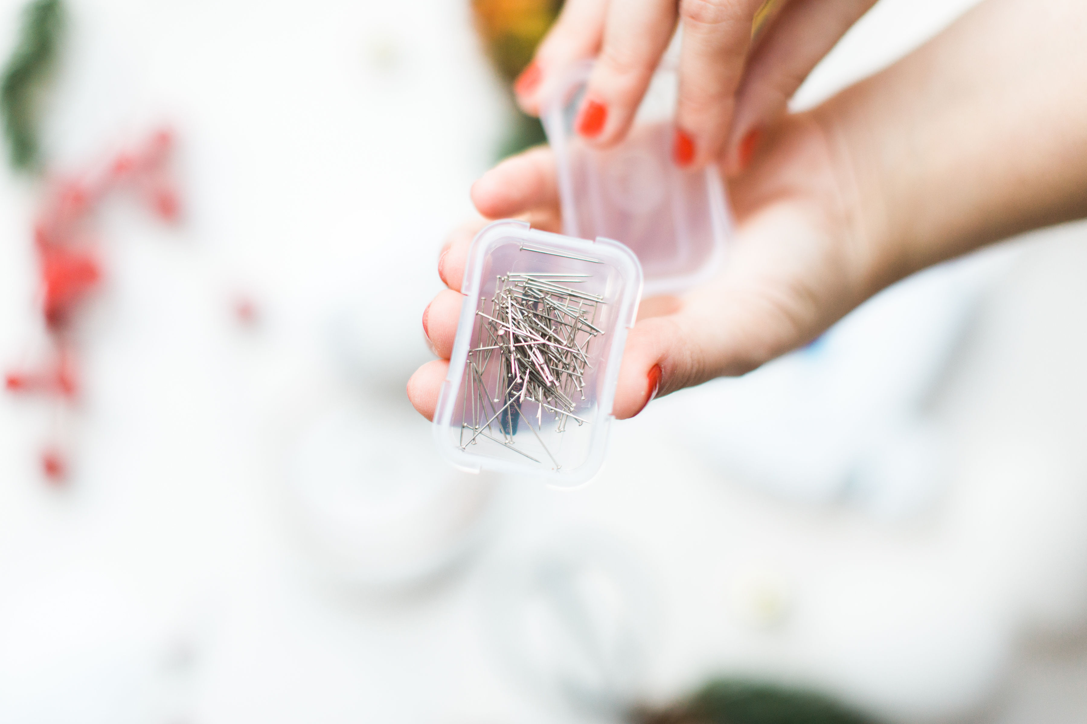 Looking for a fun Christmas craft to make this holiday season? DIY folded fabric pinecones make the prettiest ornaments, are perfect as gift toppers, and use up leftover fabric scraps - no sewing required. Click through for the details. #diyfabricpinecones #christmascraft #holidaycraft #holidaydiy #christmasdiy #nosew | glitterinc.com | @glitterinc