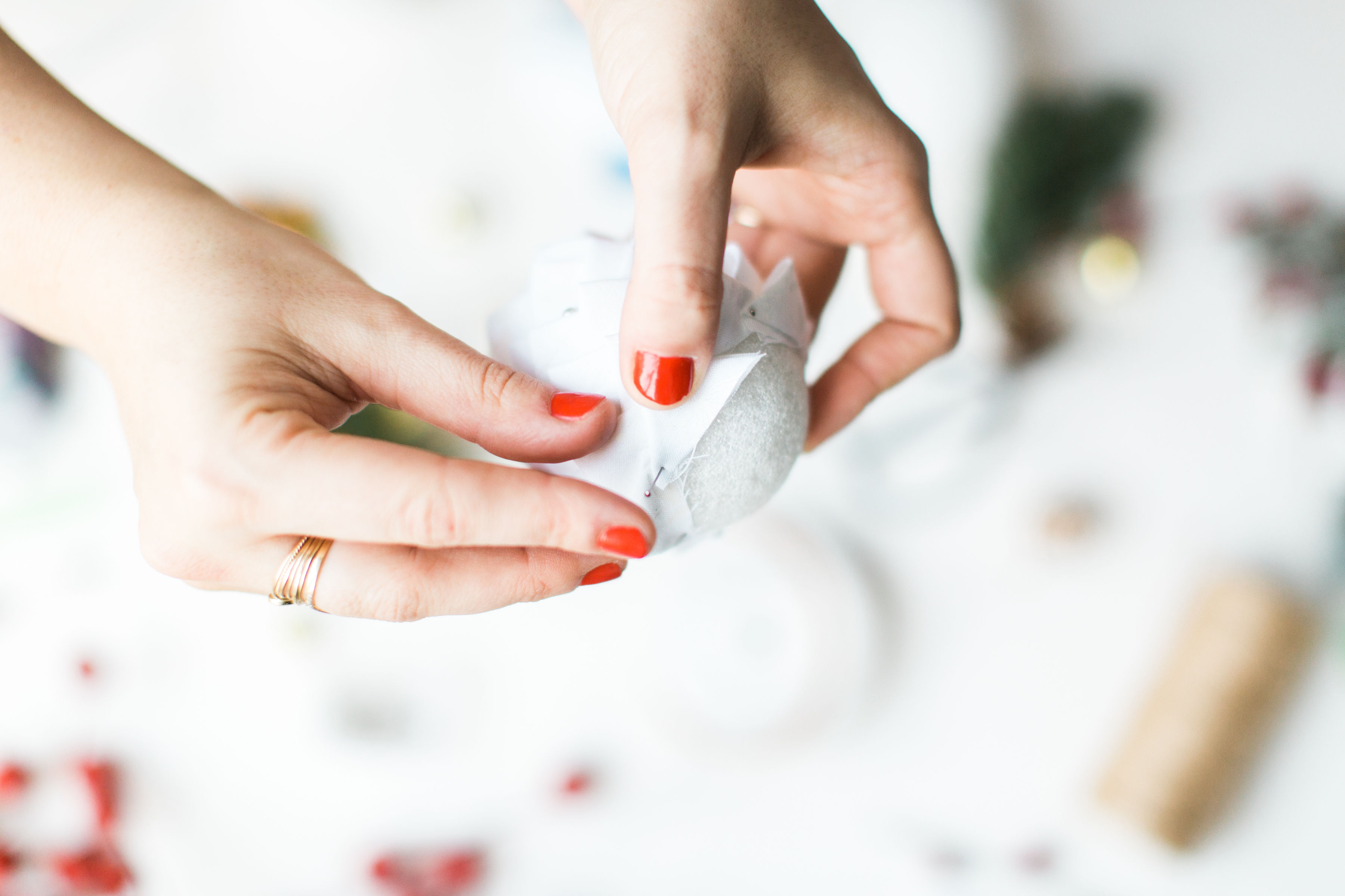 Looking for a fun Christmas craft to make this holiday season? DIY folded fabric pinecones make the prettiest ornaments, are perfect as gift toppers, and use up leftover fabric scraps - no sewing required. Click through for the details. #diyfabricpinecones #christmascraft #holidaycraft #holidaydiy #christmasdiy #nosew | glitterinc.com | @glitterinc