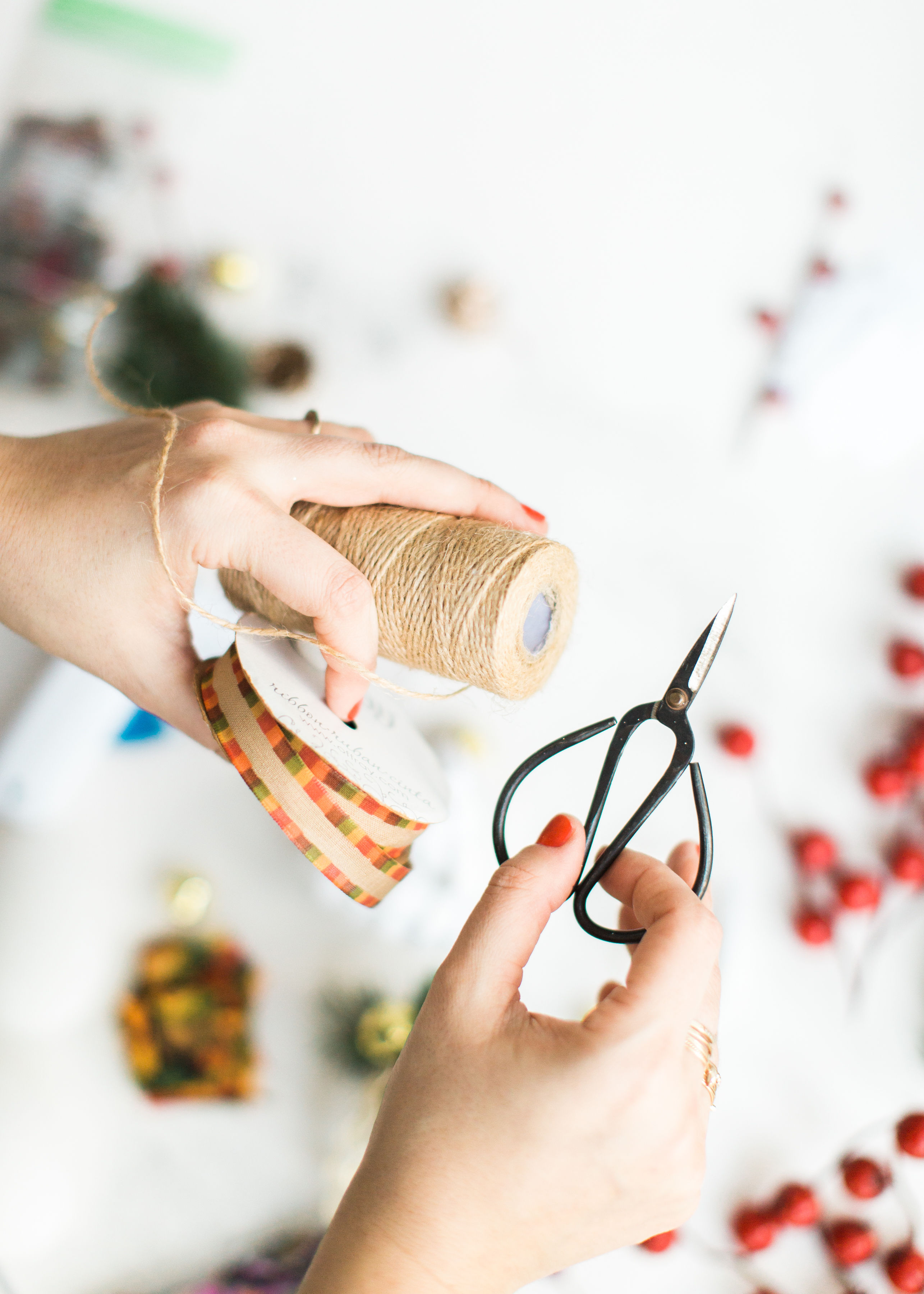 Looking for a fun Christmas craft to make this holiday season? DIY folded fabric pinecones make the prettiest ornaments, are perfect as gift toppers, and use up leftover fabric scraps - no sewing required. Click through for the details. #diyfabricpinecones #christmascraft #holidaycraft #holidaydiy #christmasdiy #nosew | glitterinc.com | @glitterinc