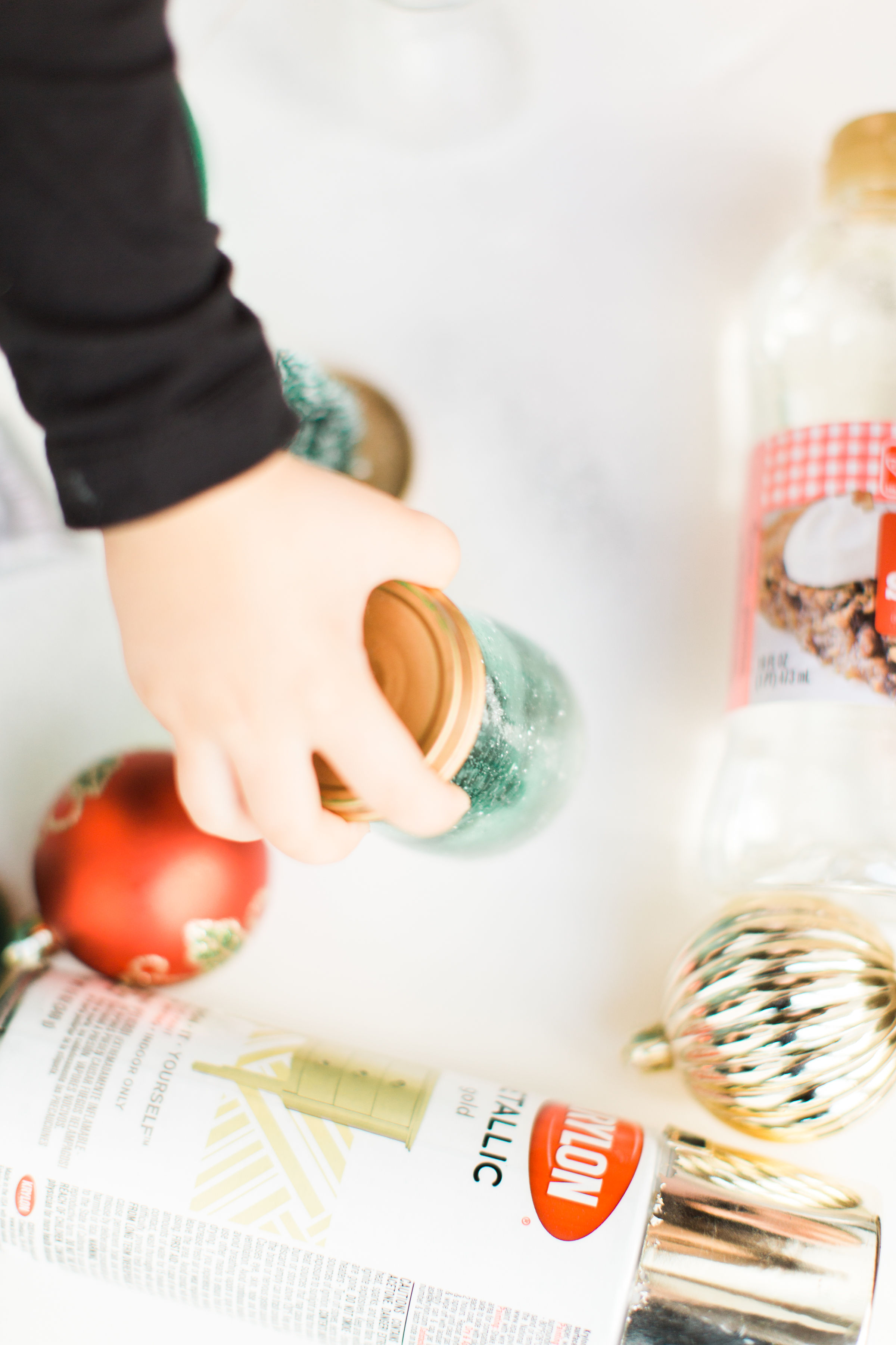 Glitter DIY snow globes are fun to make, are a great craft to do with kids, and double as a calm down sensory bottle for a little quiet time on days when the whole family is going a little stir crazy! Click through for the details. #kidsdiy #kidscraft #diysnowglobes #howtomakesnowglobes #sensorybottles #sensoryglobes #toddlercraft  #christmas #christmasdiy #christmascraft | glitterinc.com | @glitterinc