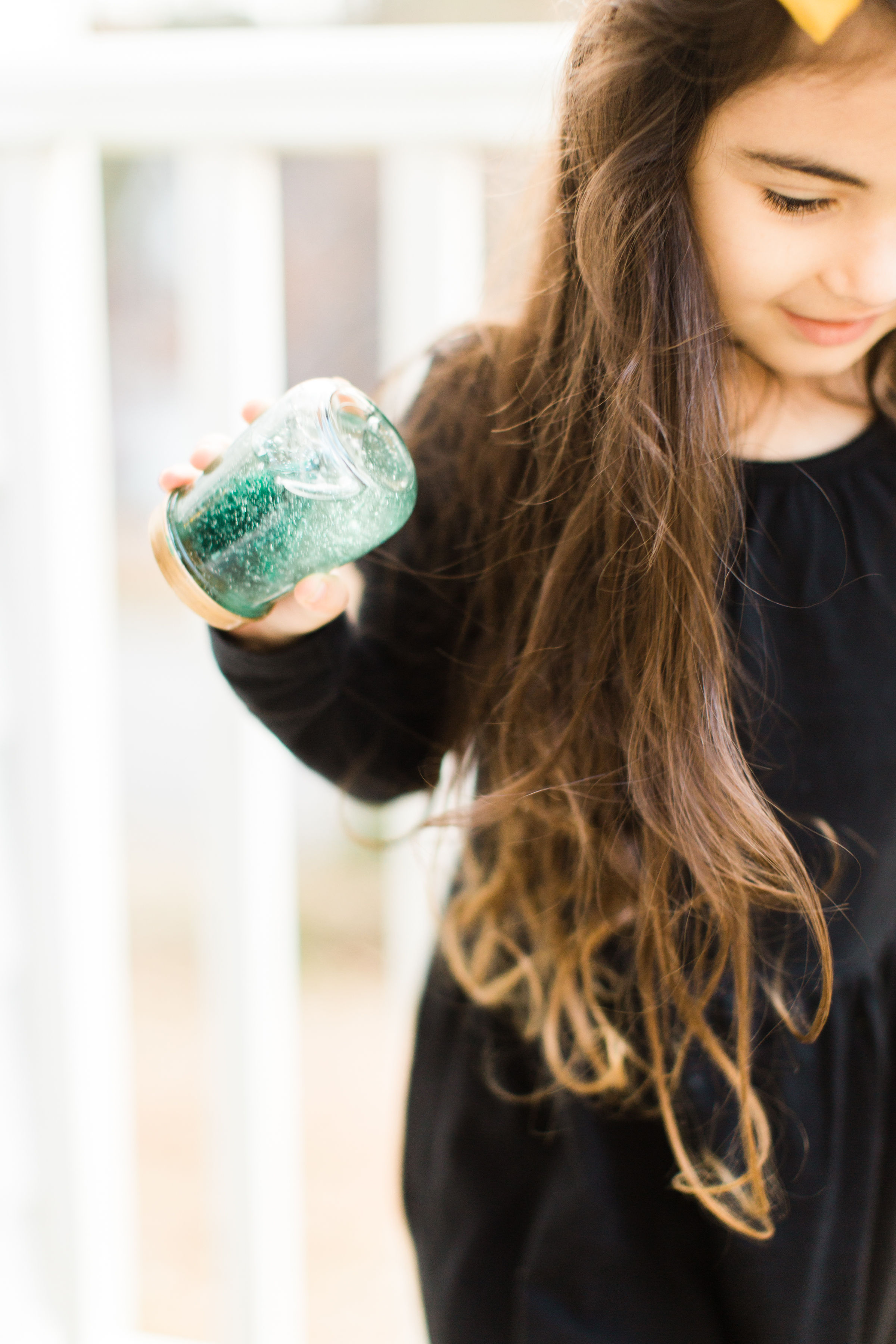 Glitter DIY snow globes are fun to make, are a great craft to do with kids, and double as a calm down sensory bottle for a little quiet time on days when the whole family is going a little stir crazy! Click through for the details. #kidsdiy #kidscraft #diysnowglobes #howtomakesnowglobes #sensorybottles #sensoryglobes #toddlercraft #wintercraft #christmas #christmasdiy #christmascraft | glitterinc.com | @glitterinc