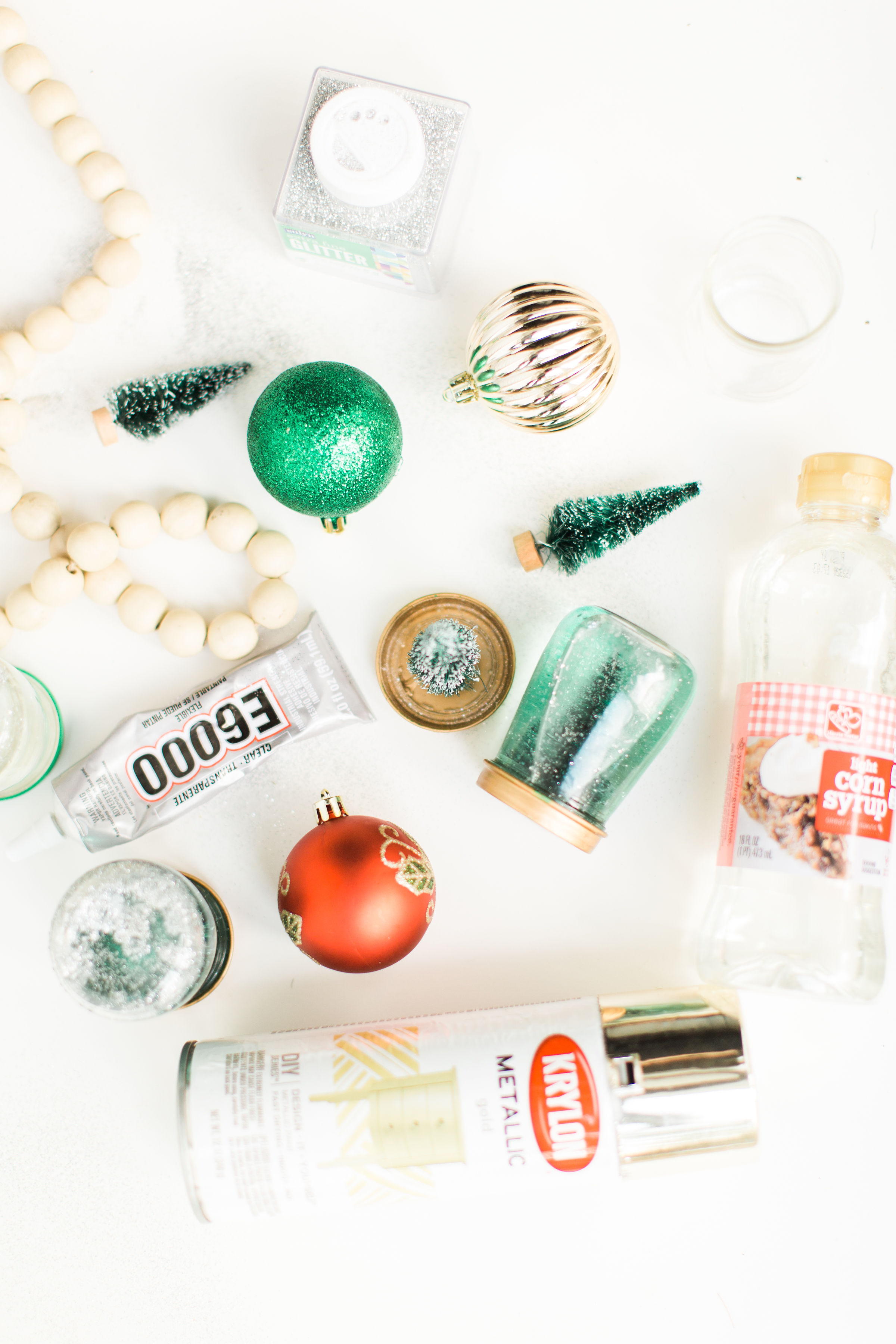 Glitter DIY snow globes are fun to make, are a great craft to do with kids, and double as a calm down sensory bottle for a little quiet time on days when the whole family is going a little stir crazy! Click through for the details. #kidsdiy #kidscraft #diysnowglobes #howtomakesnowglobes #sensorybottles #sensoryglobes  #wintercraft #christmas #christmasdiy #christmascraft | glitterinc.com | @glitterinc