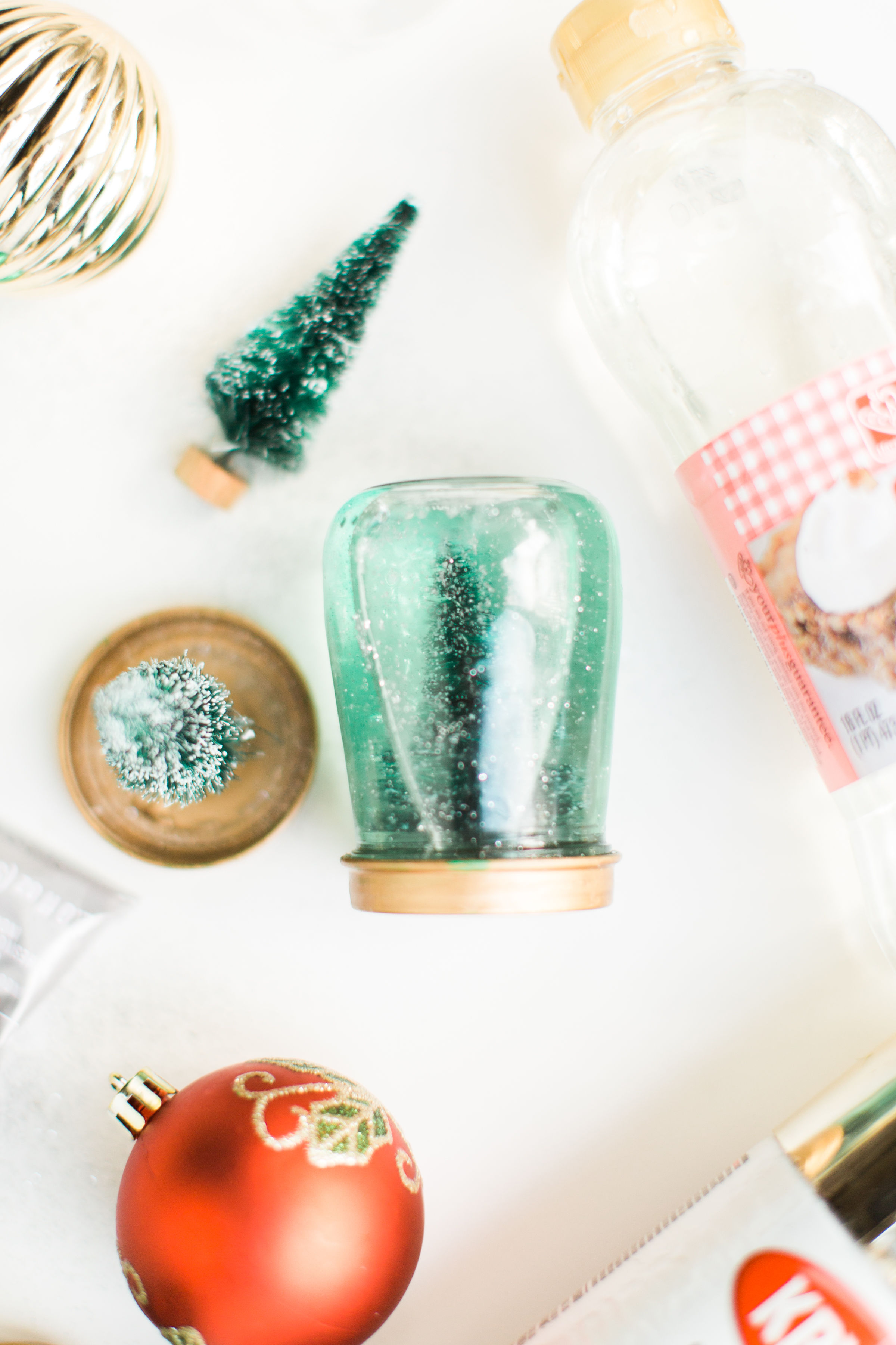 Glitter DIY snow globes are fun to make, are a great craft to do with kids, and double as a calm down sensory bottle for a little quiet time on days when the whole family is going a little stir crazy! Click through for the details. #kidsdiy #kidscraft #diysnowglobes #howtomakesnowglobes #sensorybottles #sensoryglobes #wintercraft #christmas #christmasdiy #christmascraft | glitterinc.com | @glitterinc