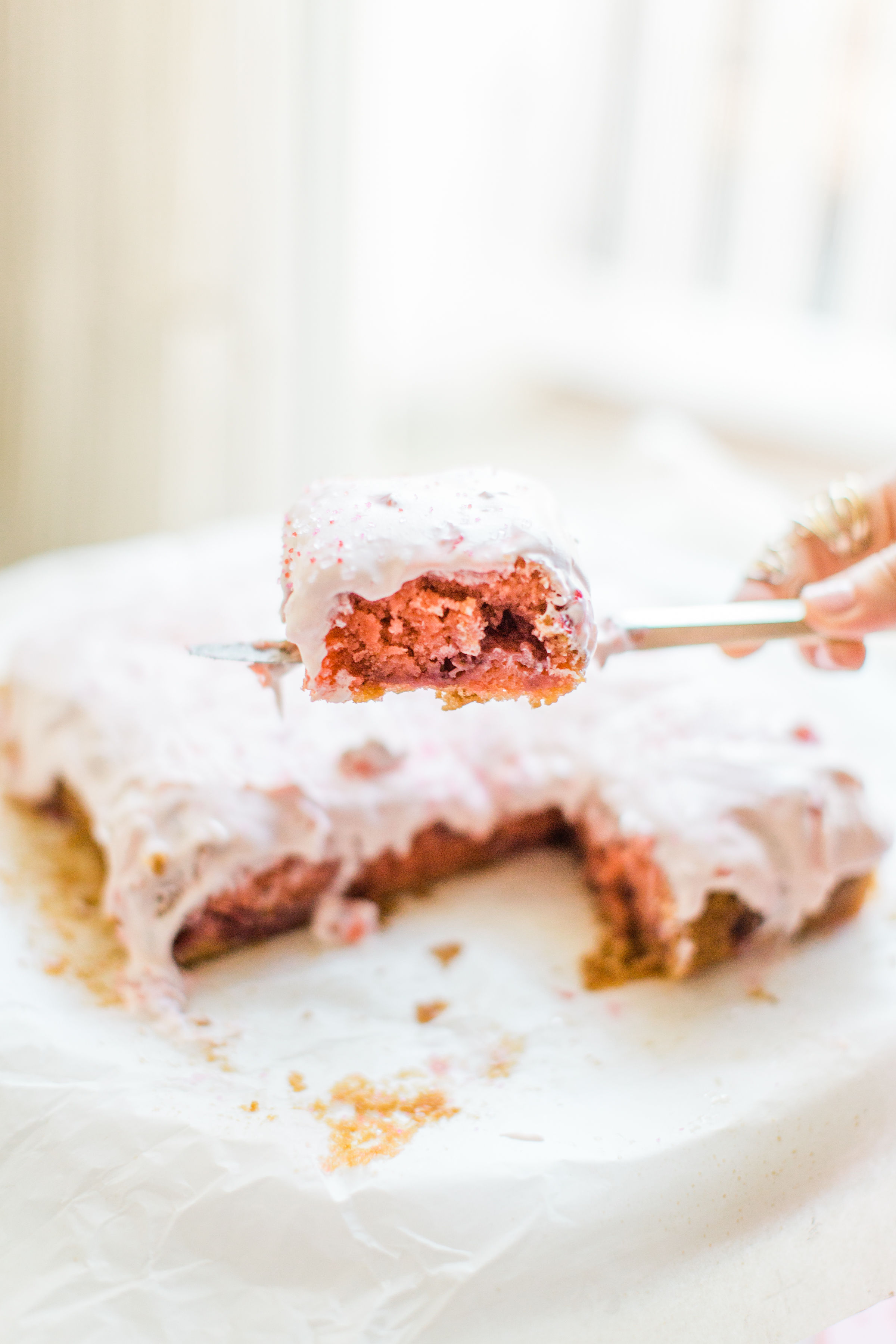 This simple homemade strawberry cake was an instant hit in our house. Easy enough to make with your kids, and bursting with fresh strawberries and topped with a decadent strawberry frosting, you'll be amazed at how moist and delicious this cake is. Click through for the recipe. #strawberrycake #kidsrecipe #easycake #easystrawberrycake #dairyfree #crazycake | glitterinc.com | @glitterinc