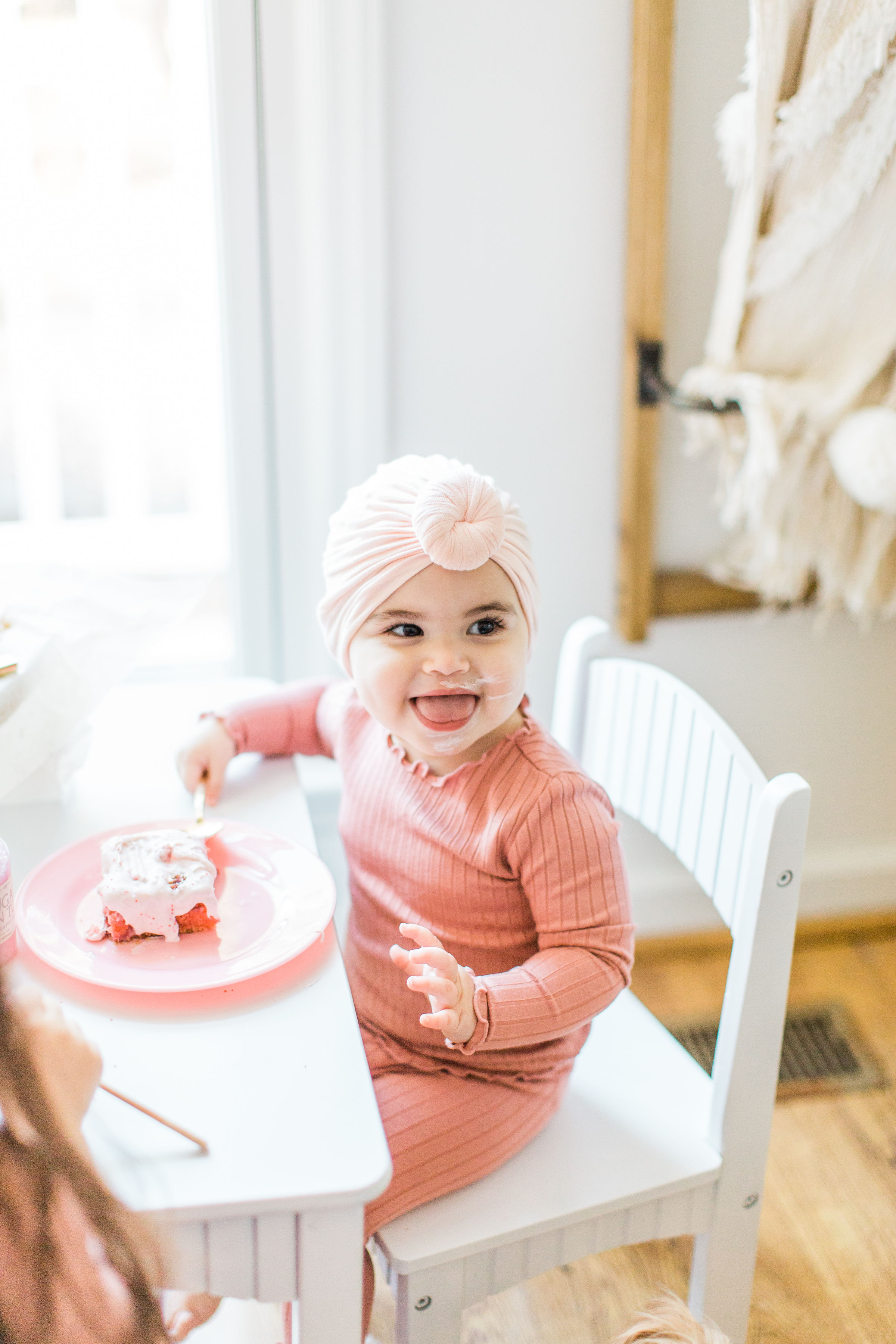 Little girl is eating a strawberry cake 