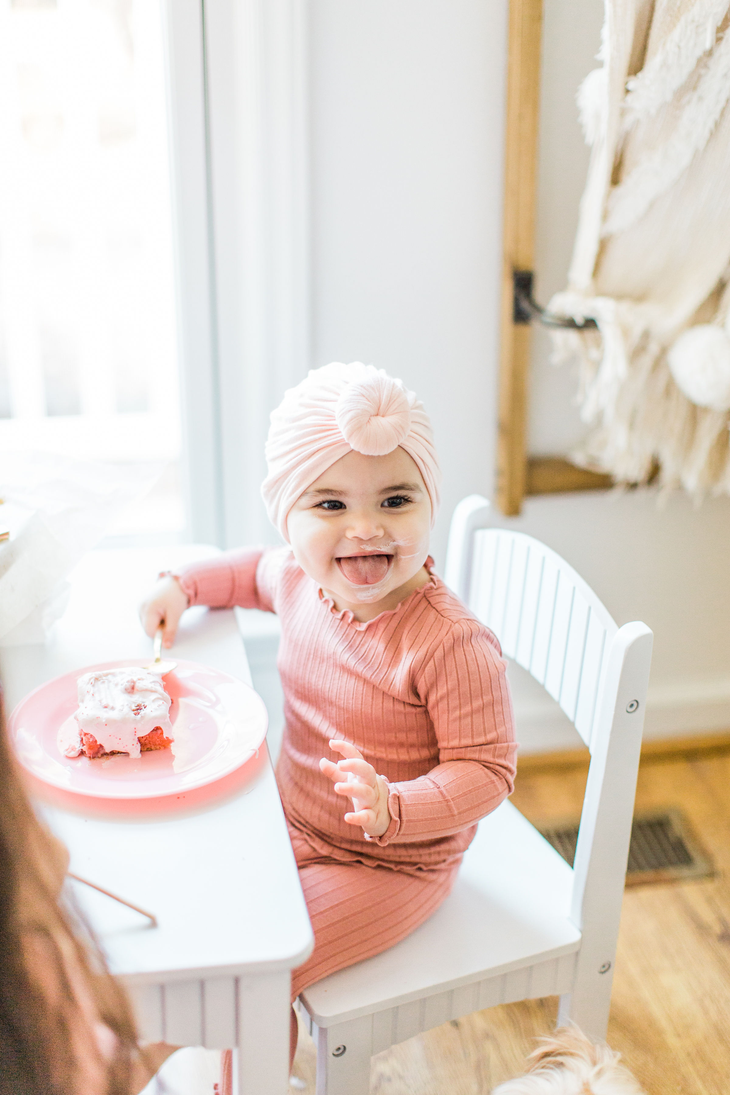 Little girl is eating a strawberry cake 