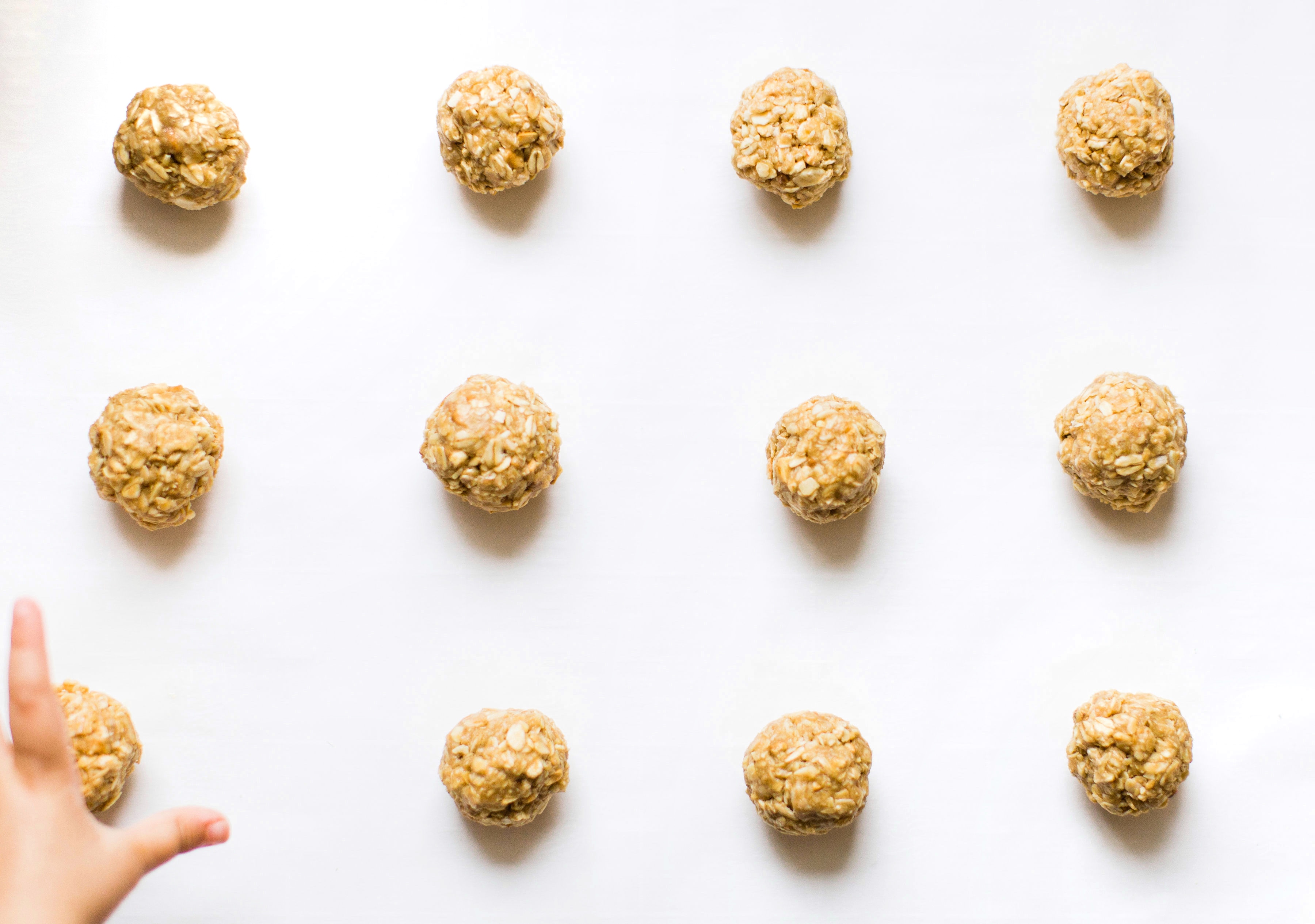 These no-bake energy bites are easy to make, the perfect combination of sweet and salty, have plenty of added protein thanks to the peanut butter, and kids absolutely love them because they're basically delicious no-bake cookies! Click through for the recipe. #snack #energybites #nobake #nobakecookies #healthysnack #kidsrecipe #kidssnack | glitterinc.com | @glitterinc