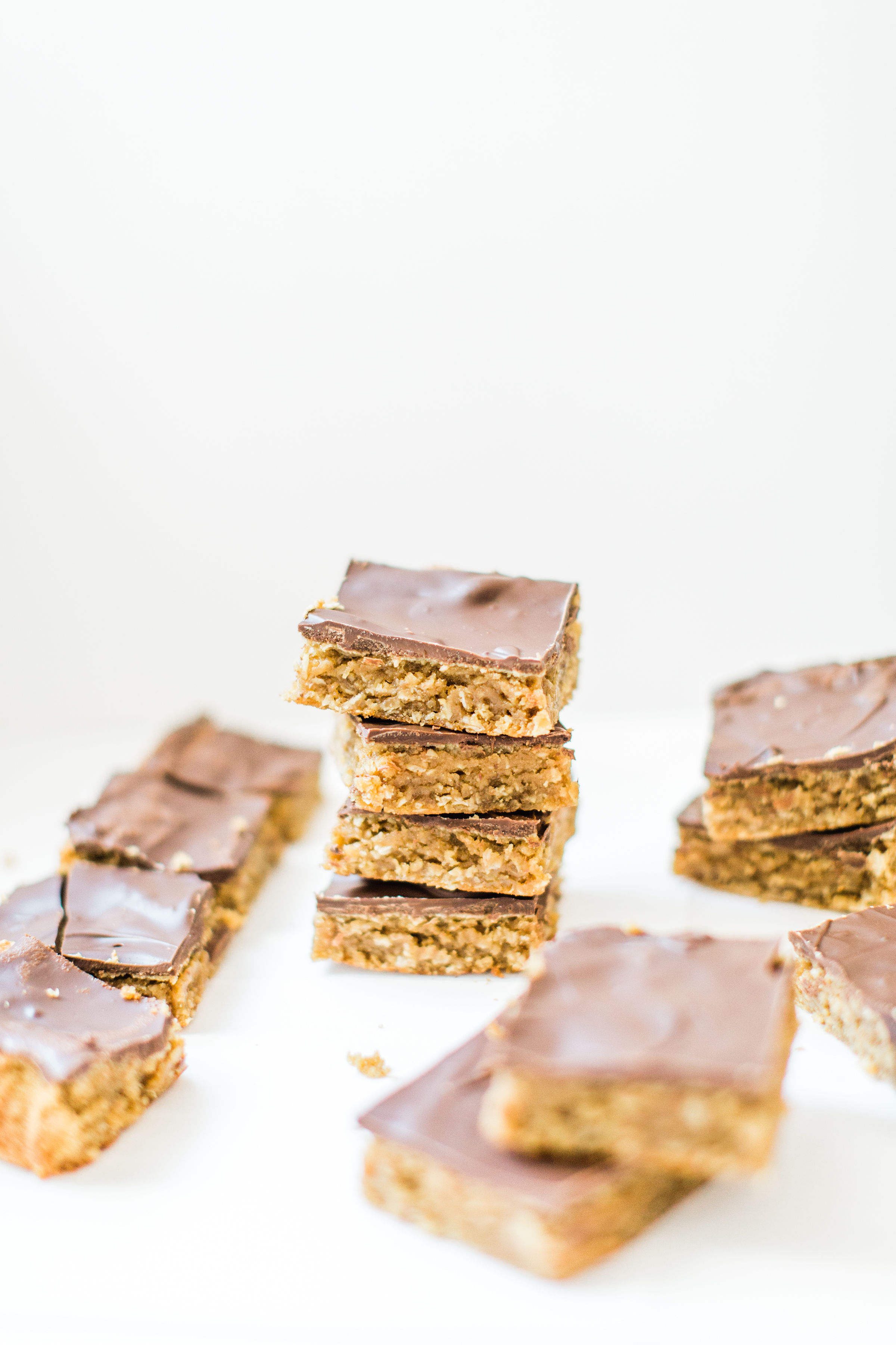 Sheet pan chocolate peanut butter oatmeal cookie bars are simple to whip up, incredibly yummy, and can easily feed a crowd. These easy cookies are a total fan favorite! Click through for the recipe. | glitterinc.com | @glitterinc