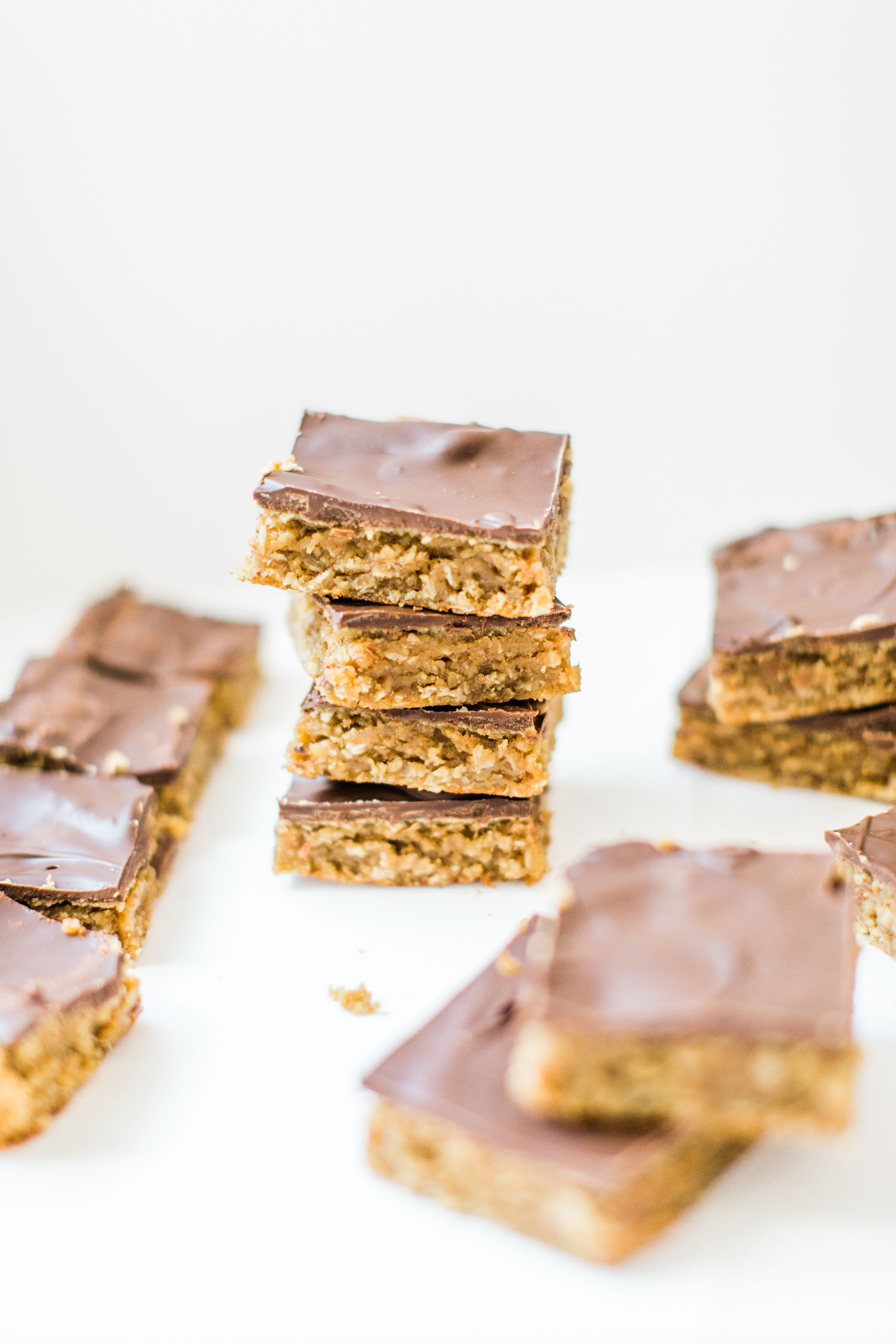 Sheet pan chocolate peanut butter oatmeal cookie bars are simple to whip up, incredibly yummy, and can easily feed a crowd. These easy cookies are a total fan favorite! Click through for the recipe. | glitterinc.com | @glitterinc