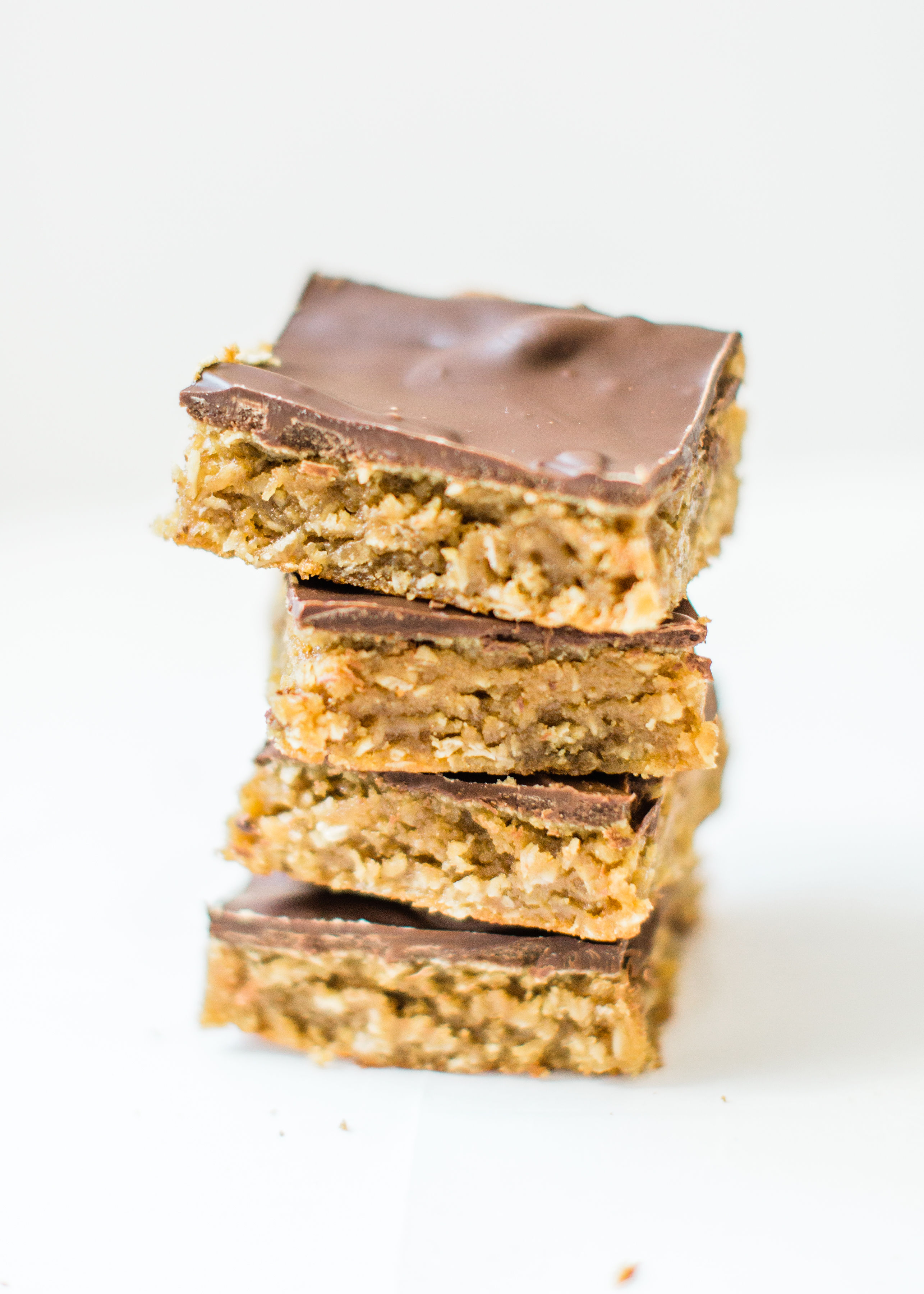 Sheet pan chocolate peanut butter oatmeal cookie bars are simple to whip up, incredibly yummy, and can easily feed a crowd. These easy cookies are a total fan favorite! Click through for the recipe. | glitterinc.com | @glitterinc